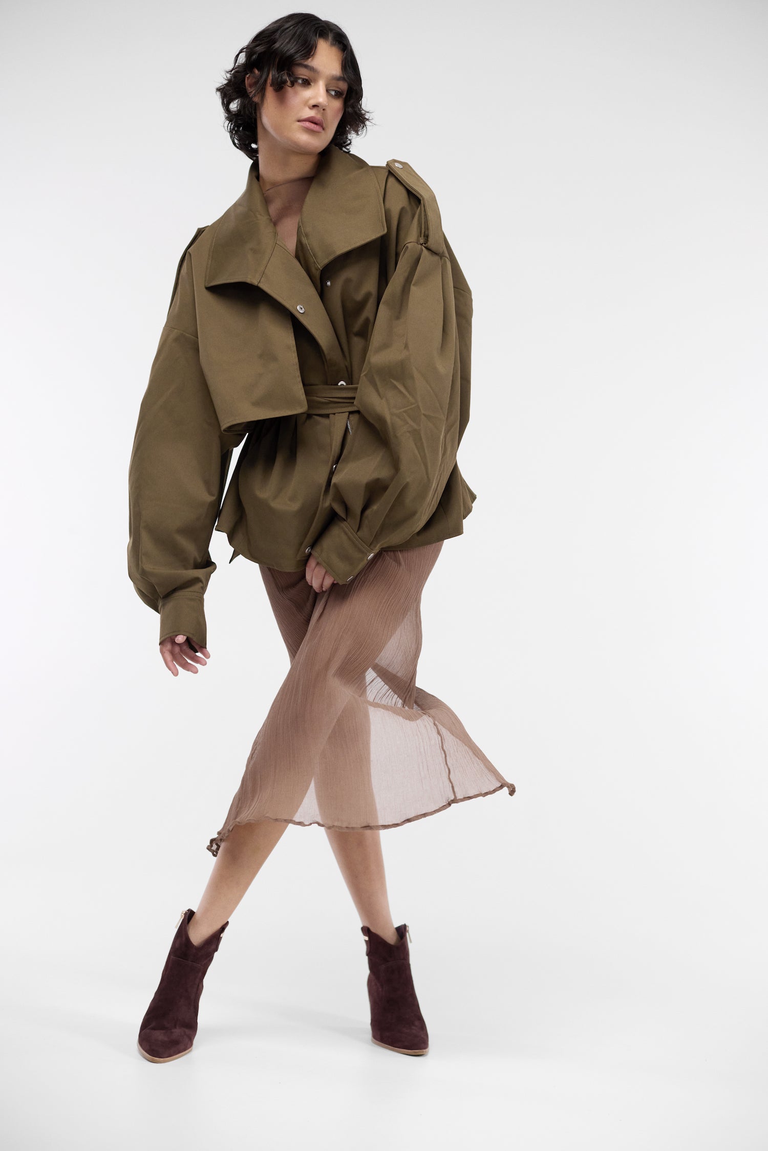 Woman wearing 7.5cm ankle boot in brown suede.