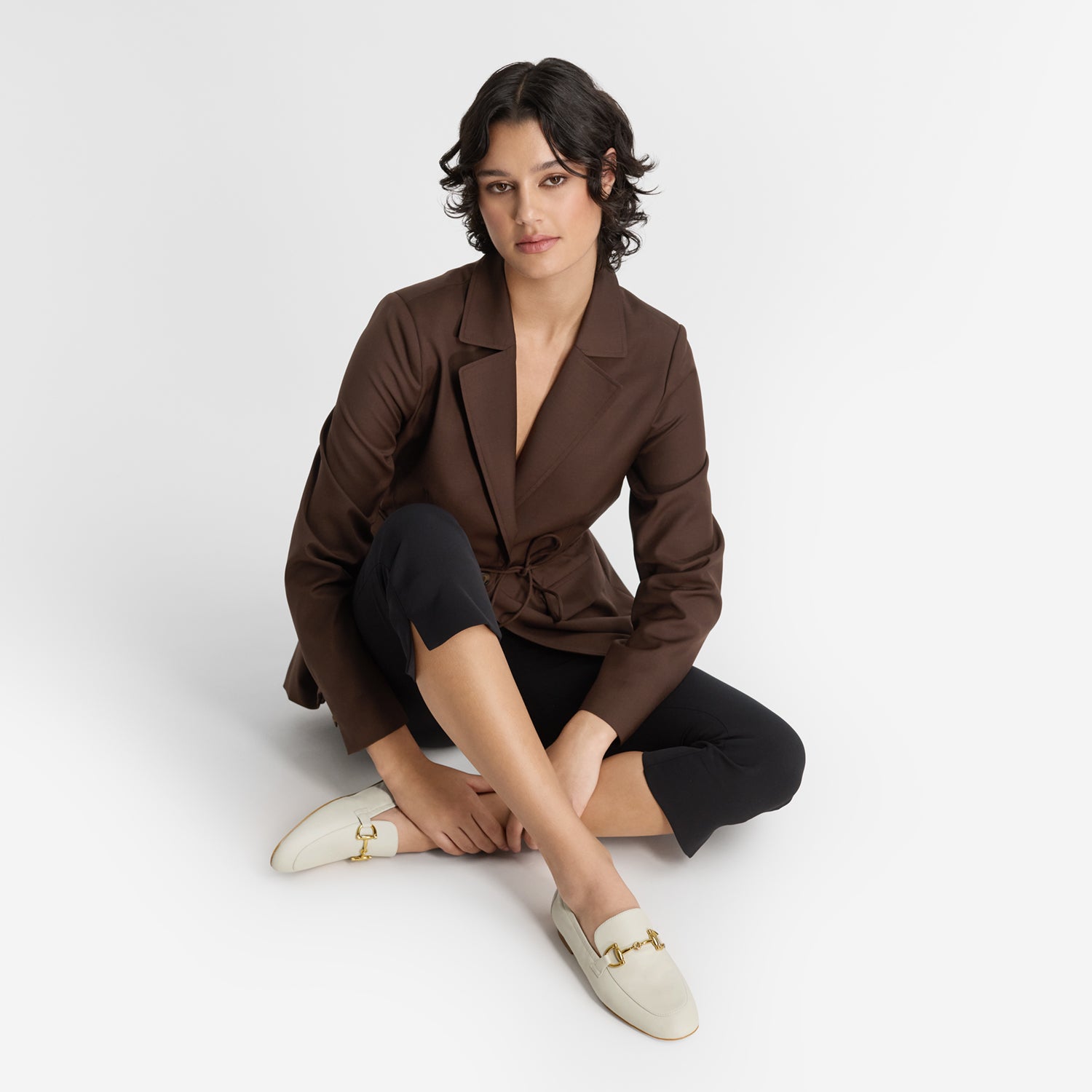Model wearing Nicole Rebstock's vanilla leather flat loafers called Mel.