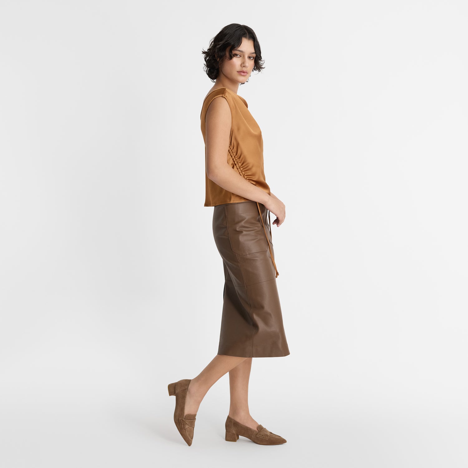Model wearing Nicole Rebstock's pointed loafers in coco suede with a 4cm block heel.