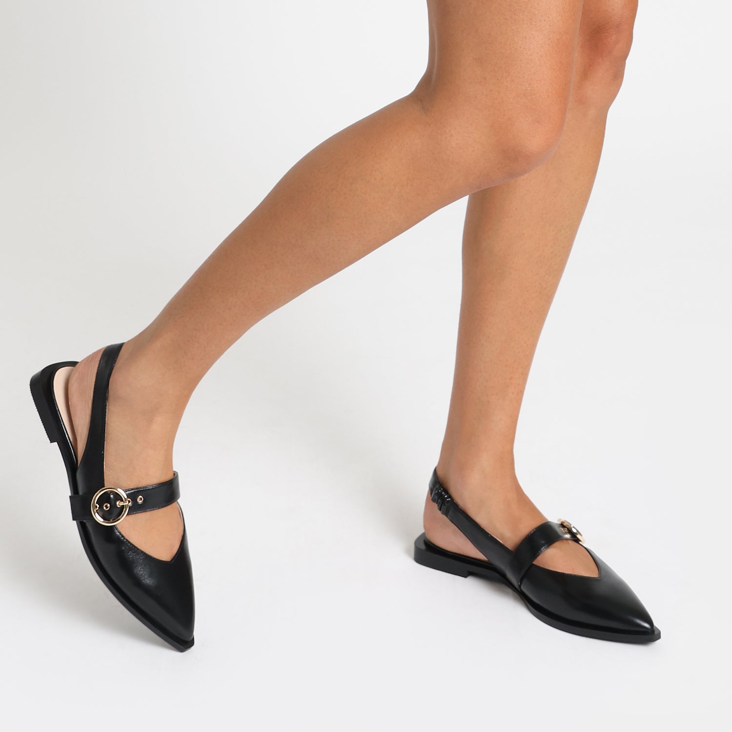 Valencia black oiled leather slingback with pointed toe, gold buckle shown on women's feet.