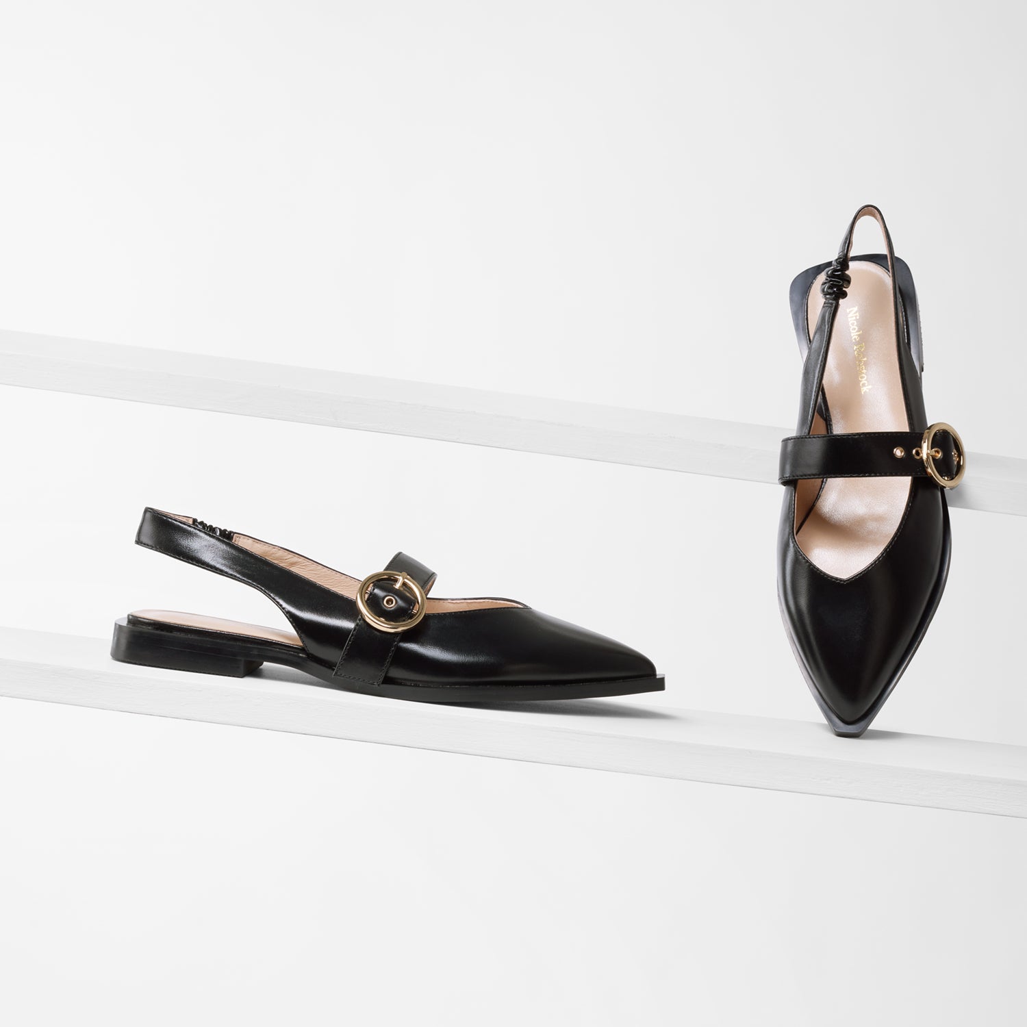 Valencia black oil leather sling back with pointed toe on planks showing all angles, Gold buckle and straps.