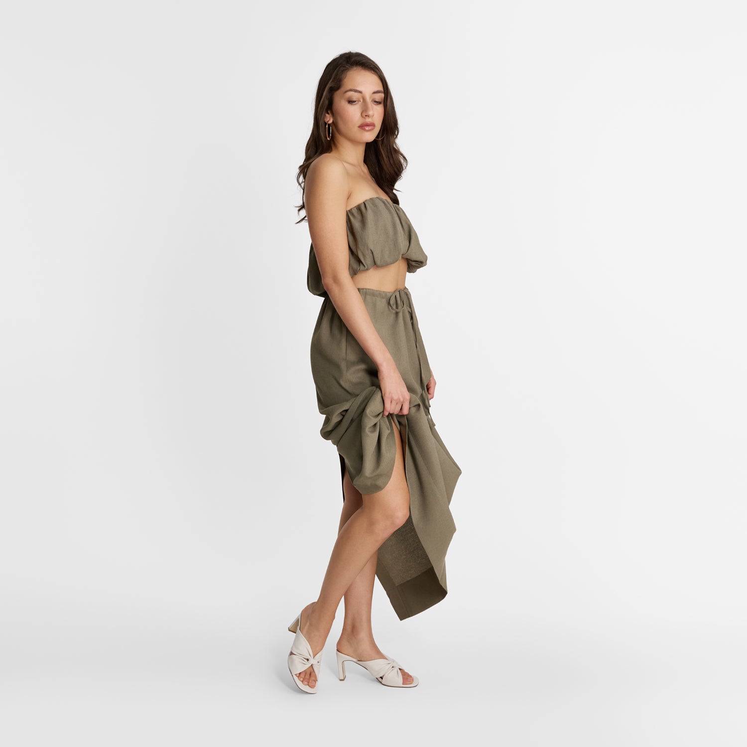 Woman wearing ivory mules with mid heel by Nicole Rebstock