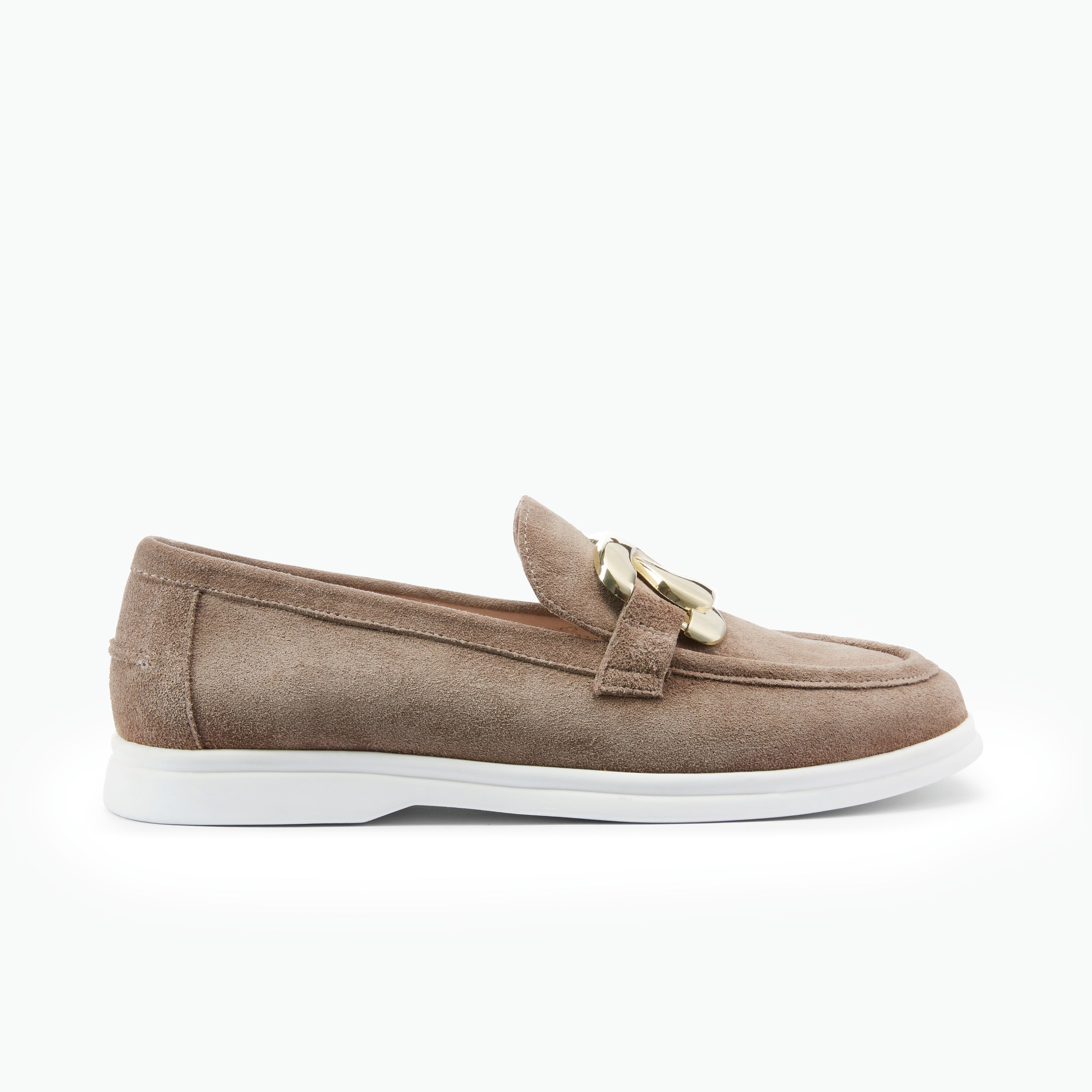 Brown suede loafer with a gold buckle on a white background