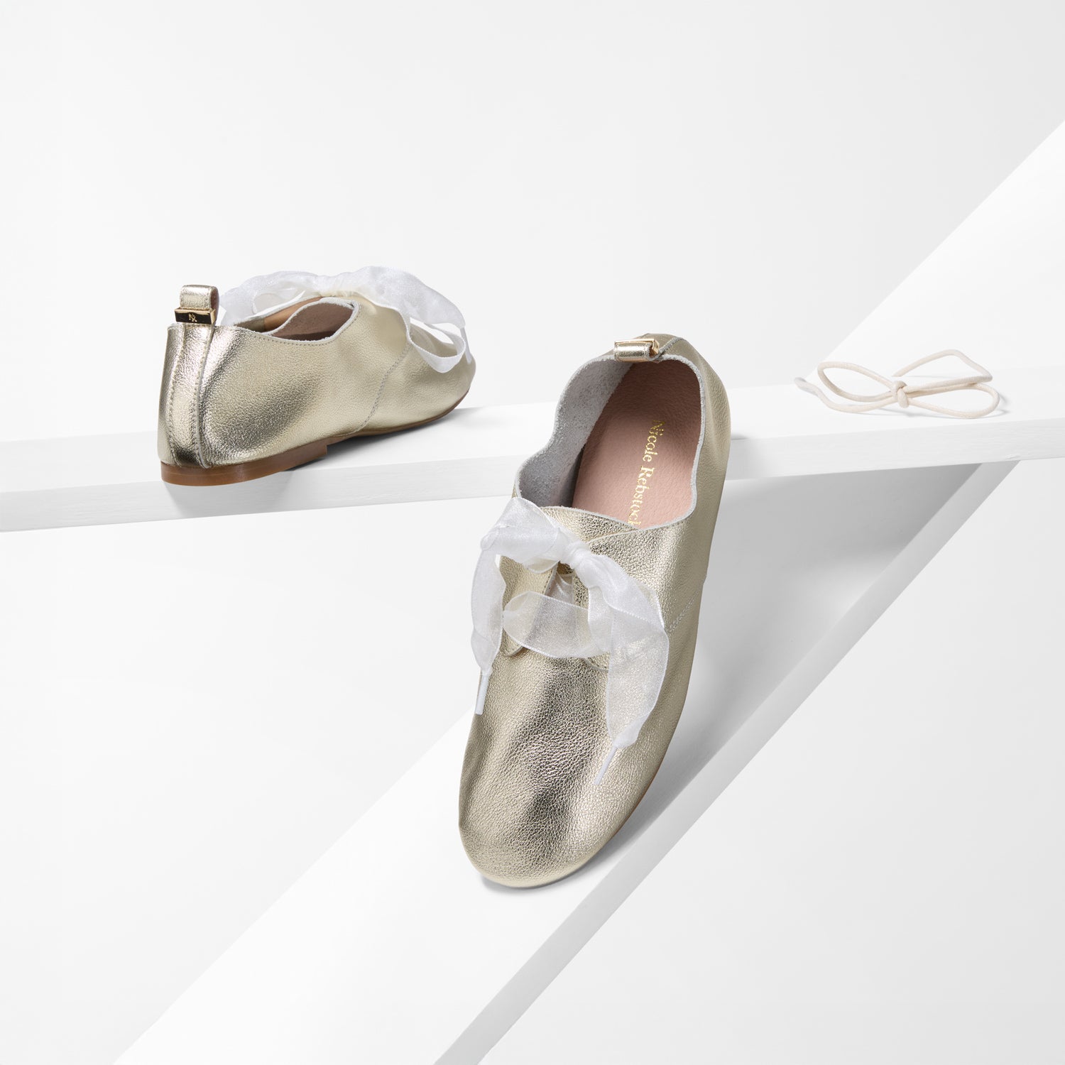 Gold unstructured flats with laces by Nicole Rebstock.