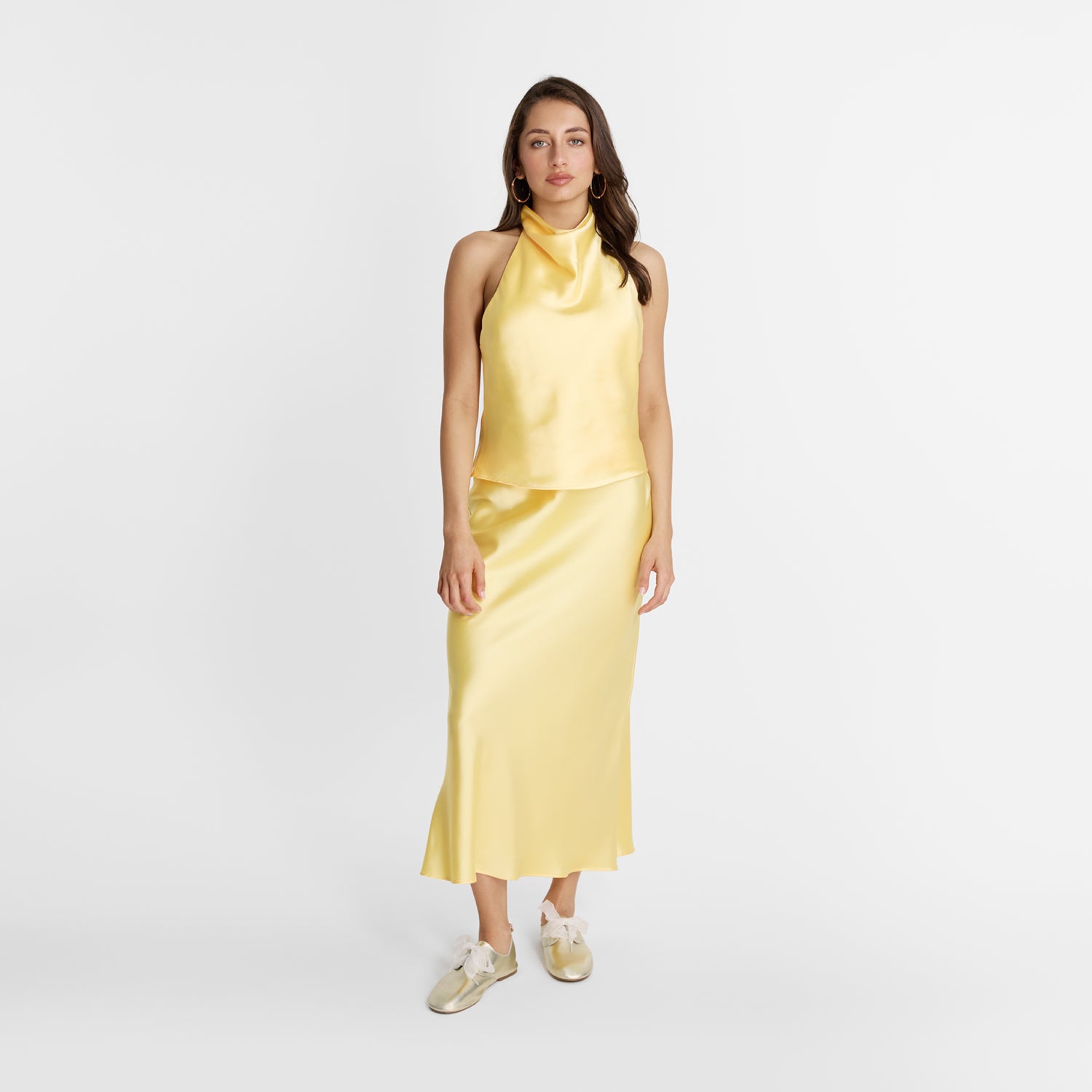 Model wearing gold Xenia flats with laces by Nicole Rebstock.