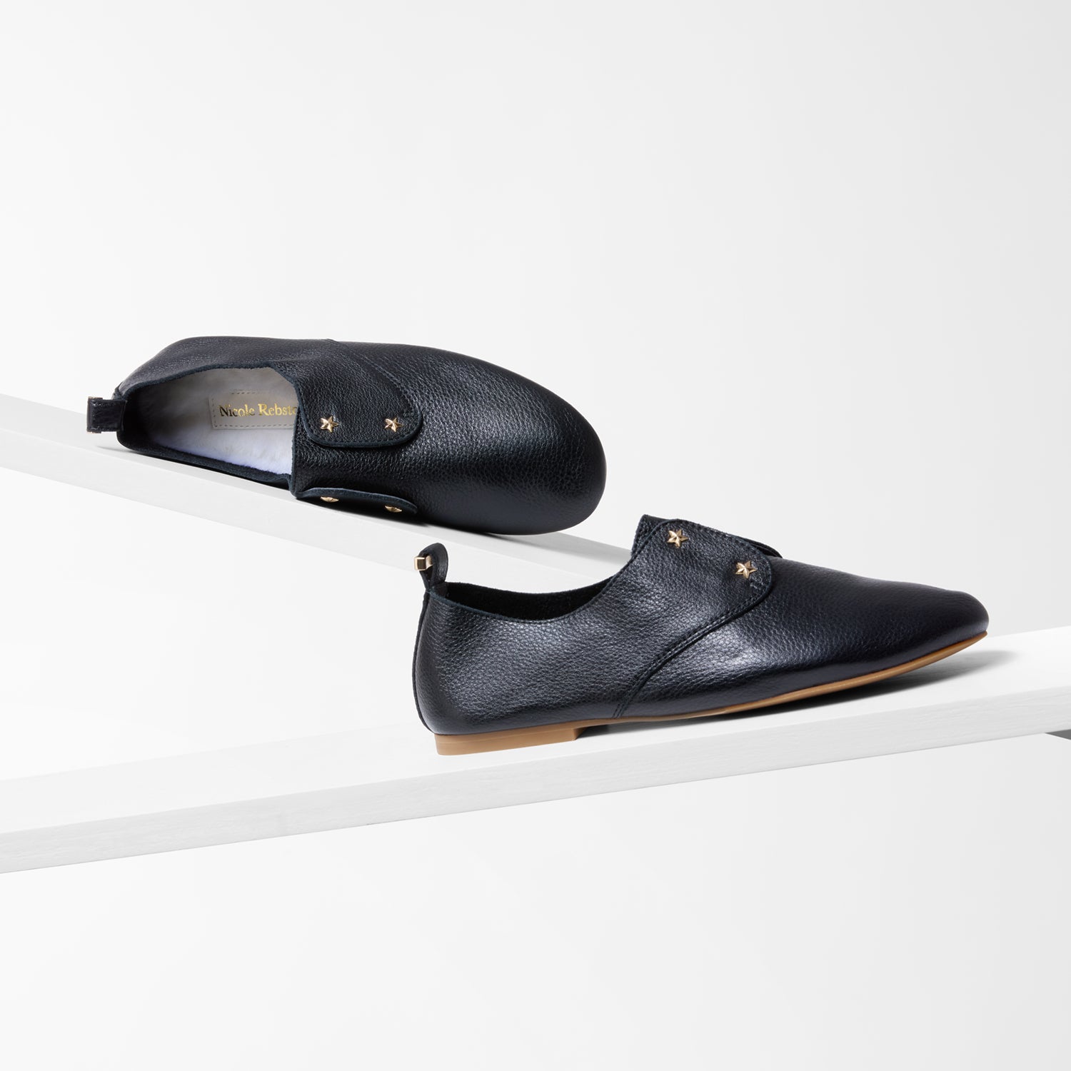 Black pebble leather slip on flats with wool insole.