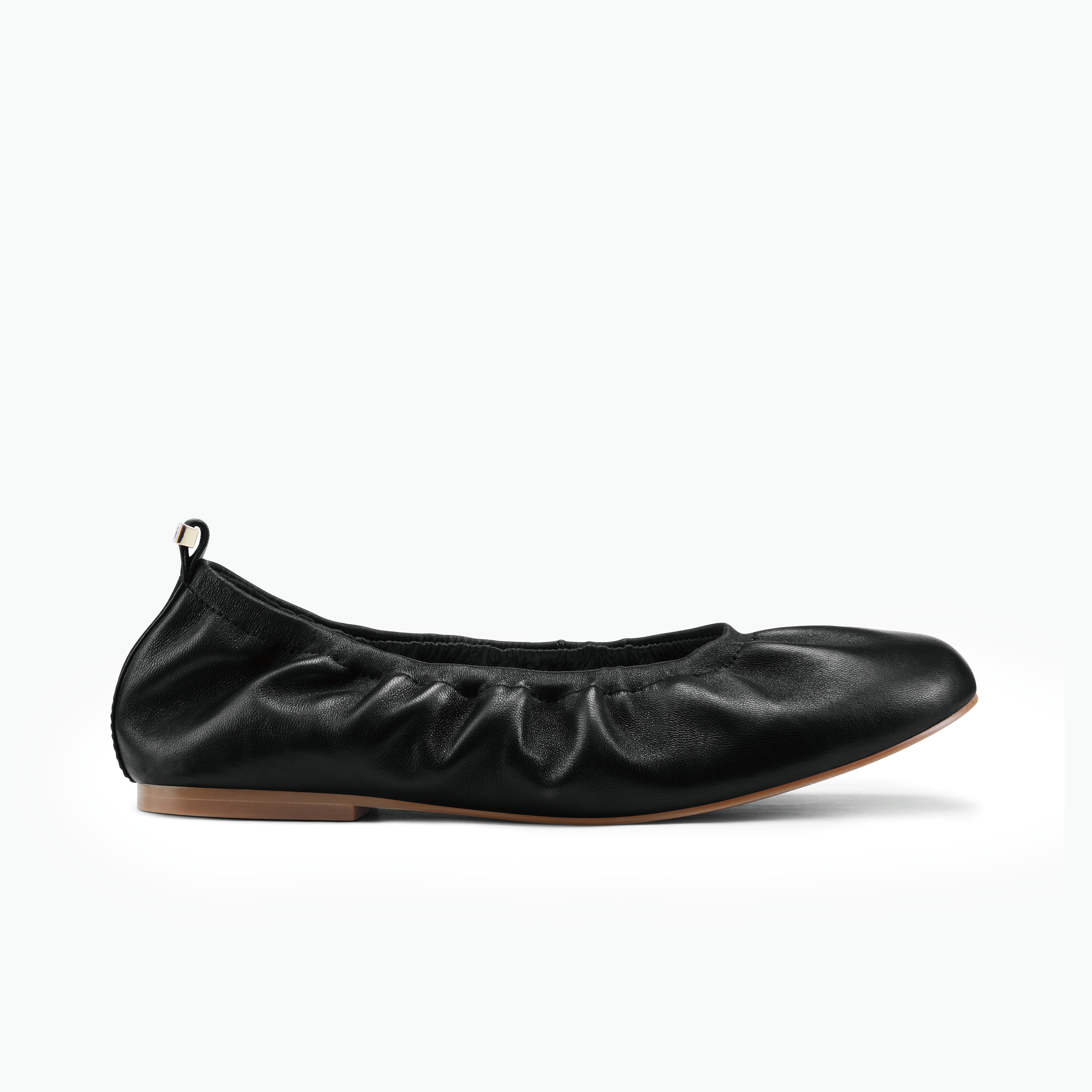 Xia black ballet flats on white background