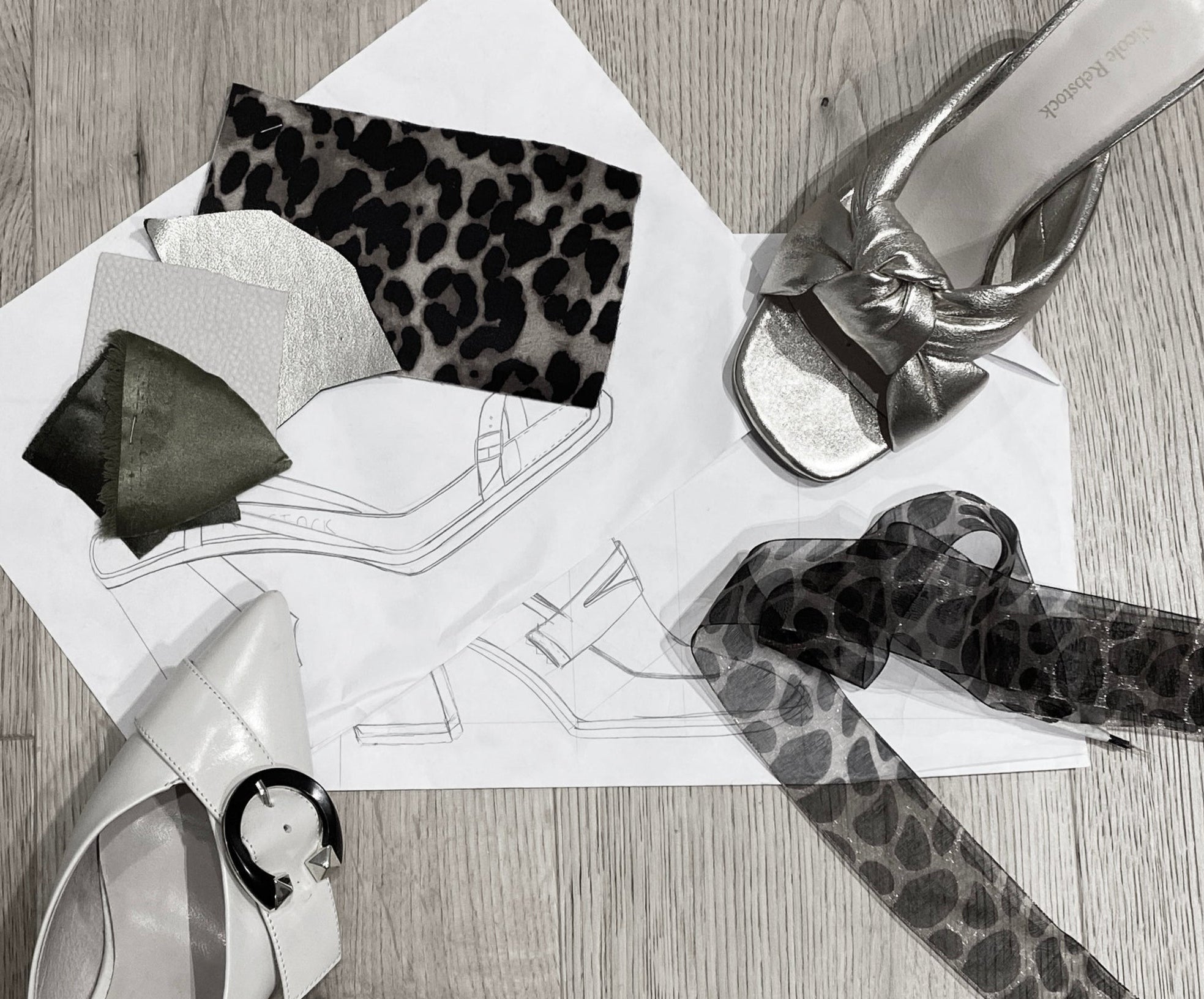 High-heeled shoes with leopard print belts on a wooden floor