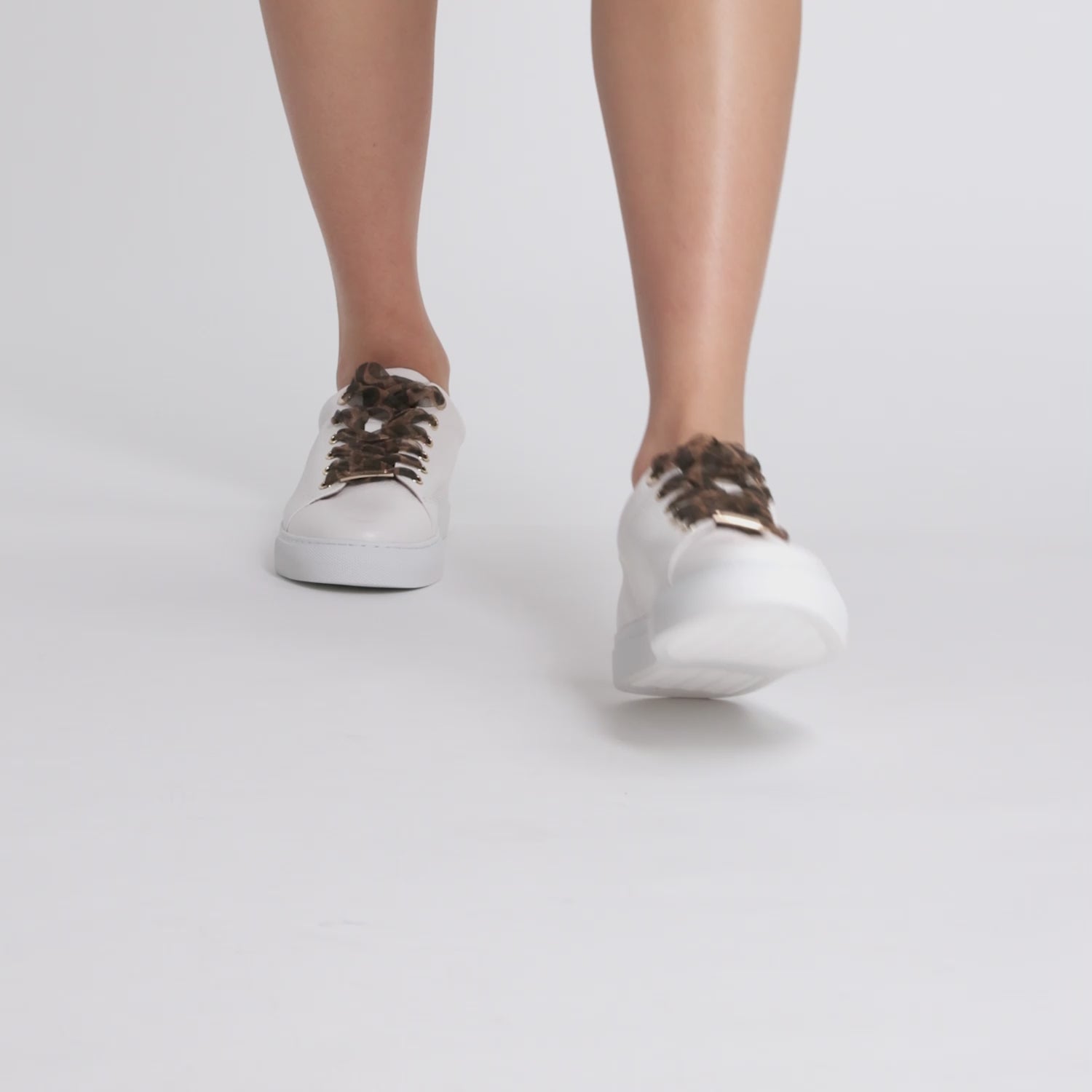 video of women wearing best selling Mace sneaker in white with leopard laces.
