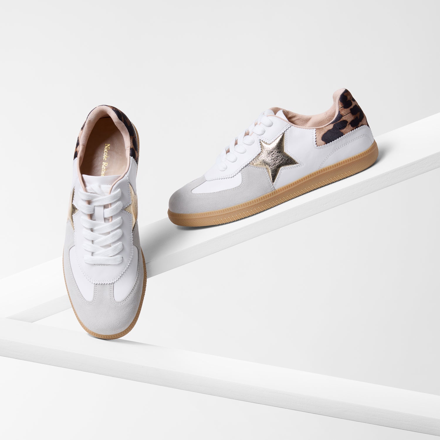 White sneakers with star design and leopard print accents on a white background