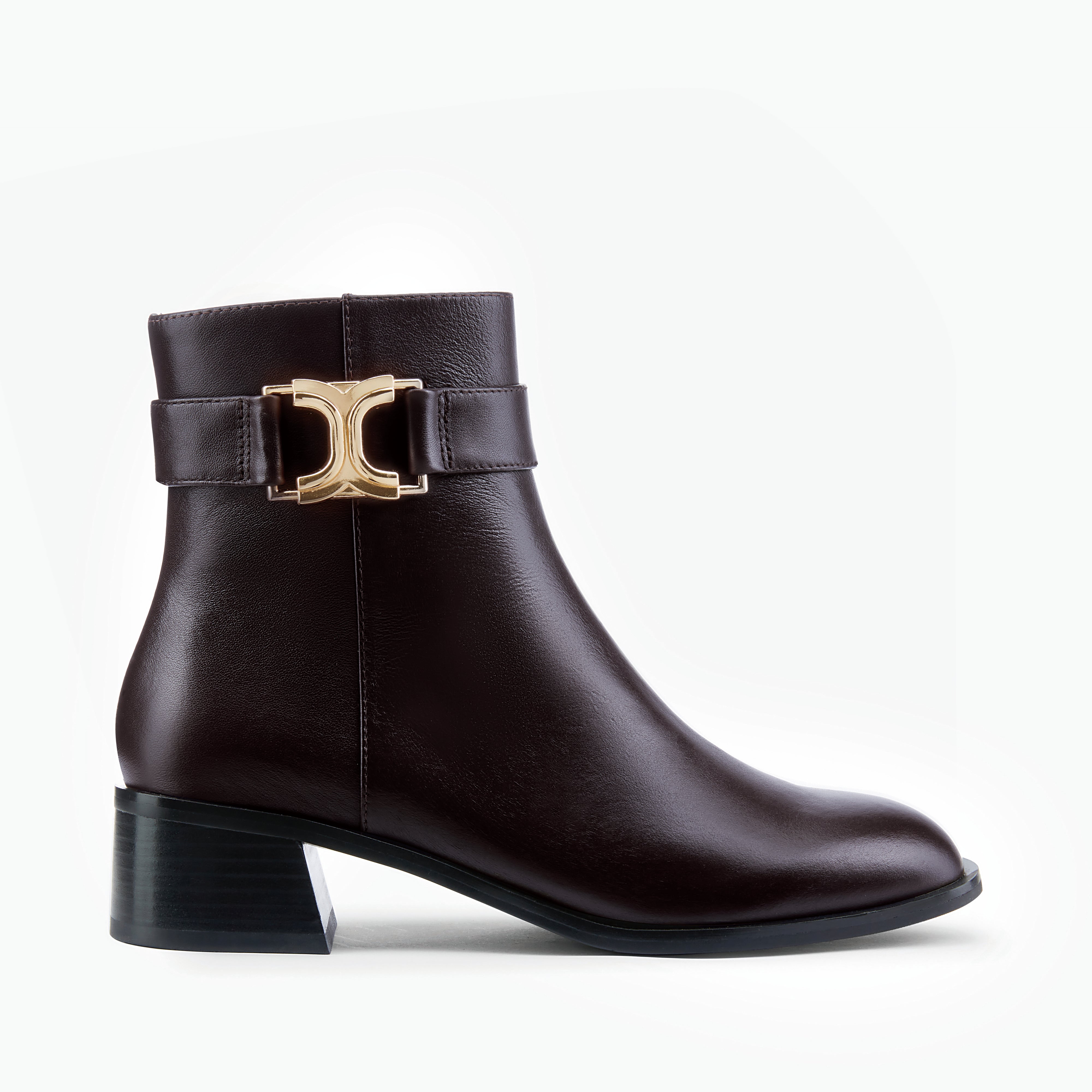 Brown ankle boot with gold buckle and zip. Round toe.