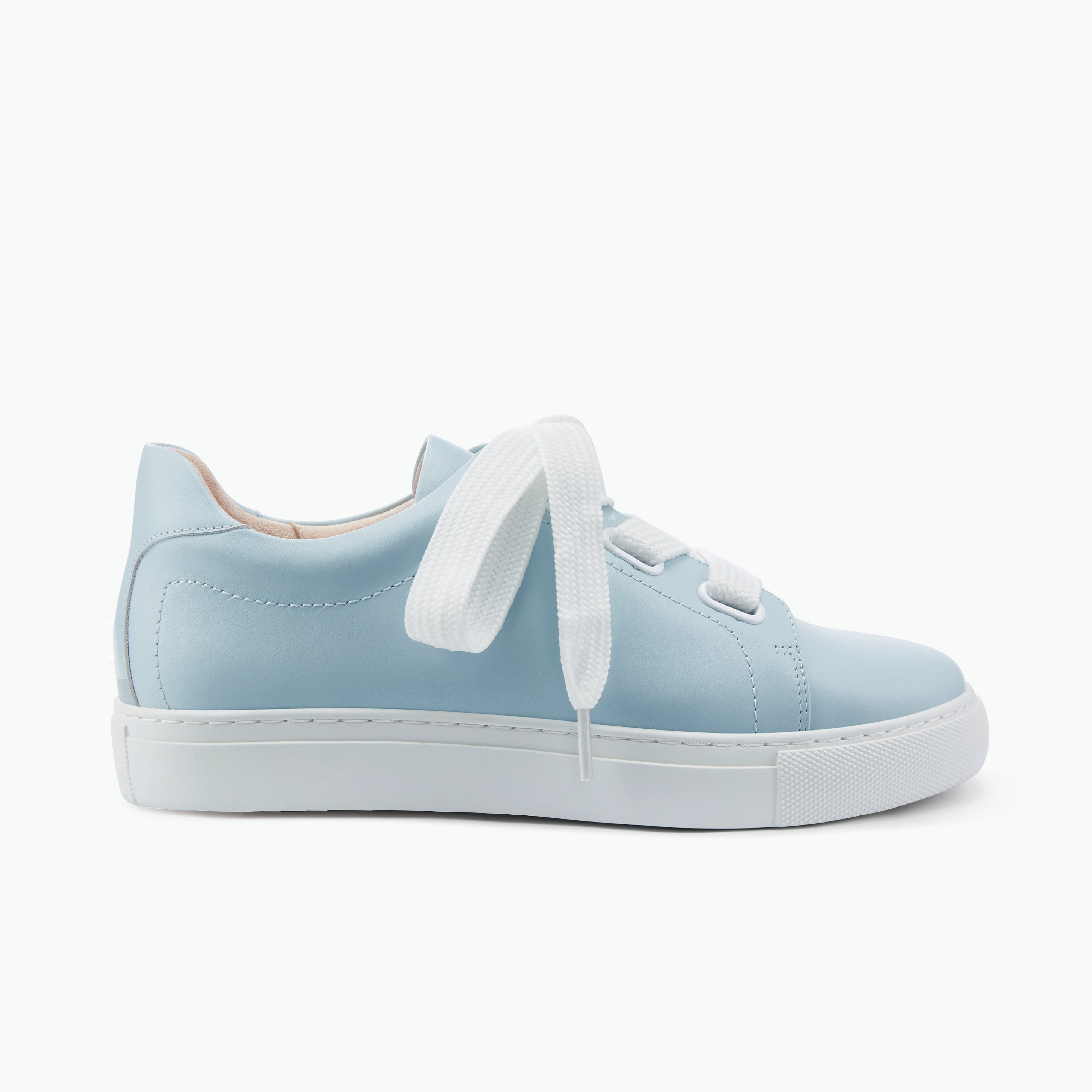 Nicole Rebstock powder blue sneaker called Blaize, with white laces on a white background