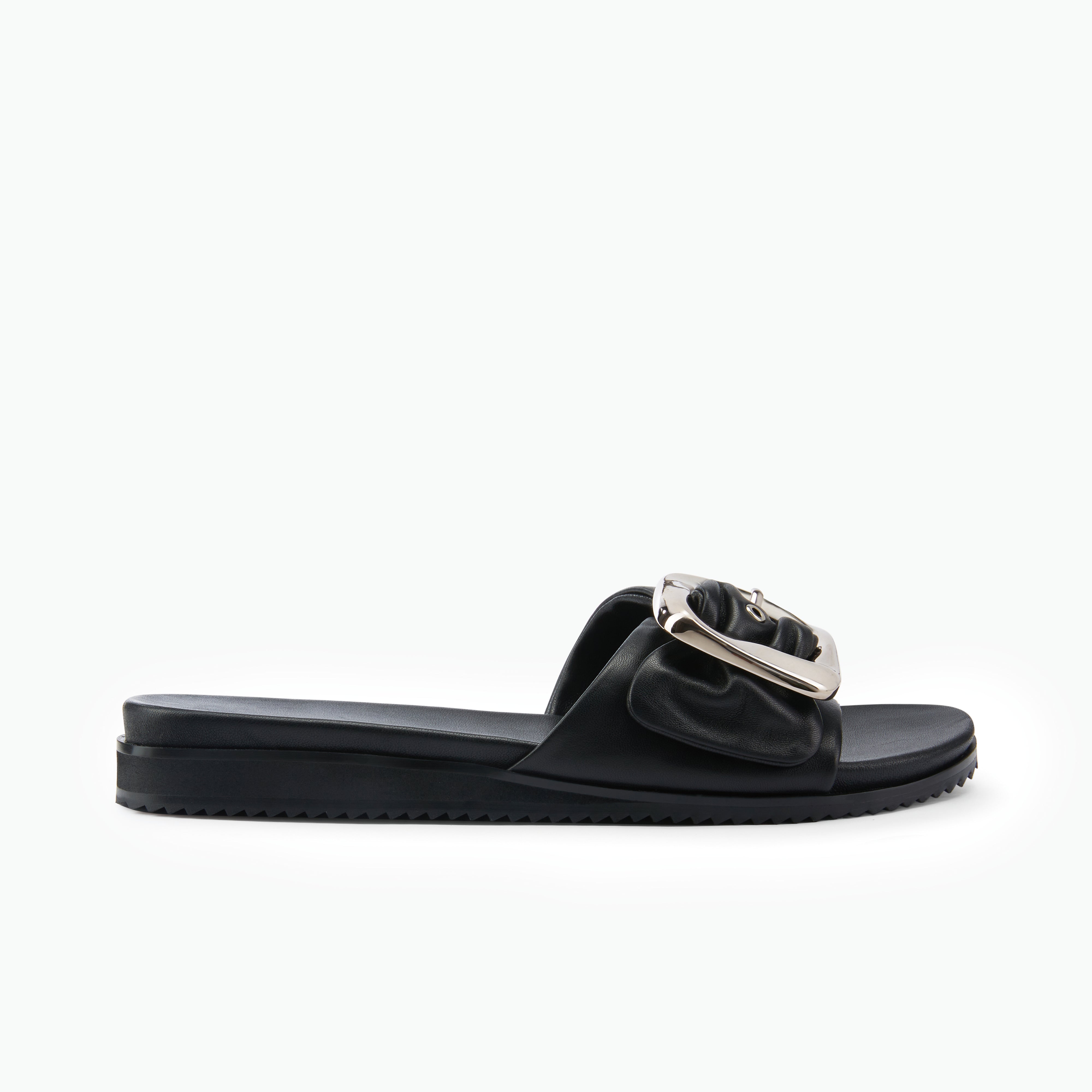 Black sandal slide by Nicole Rebstock with a silver buckle on a white background