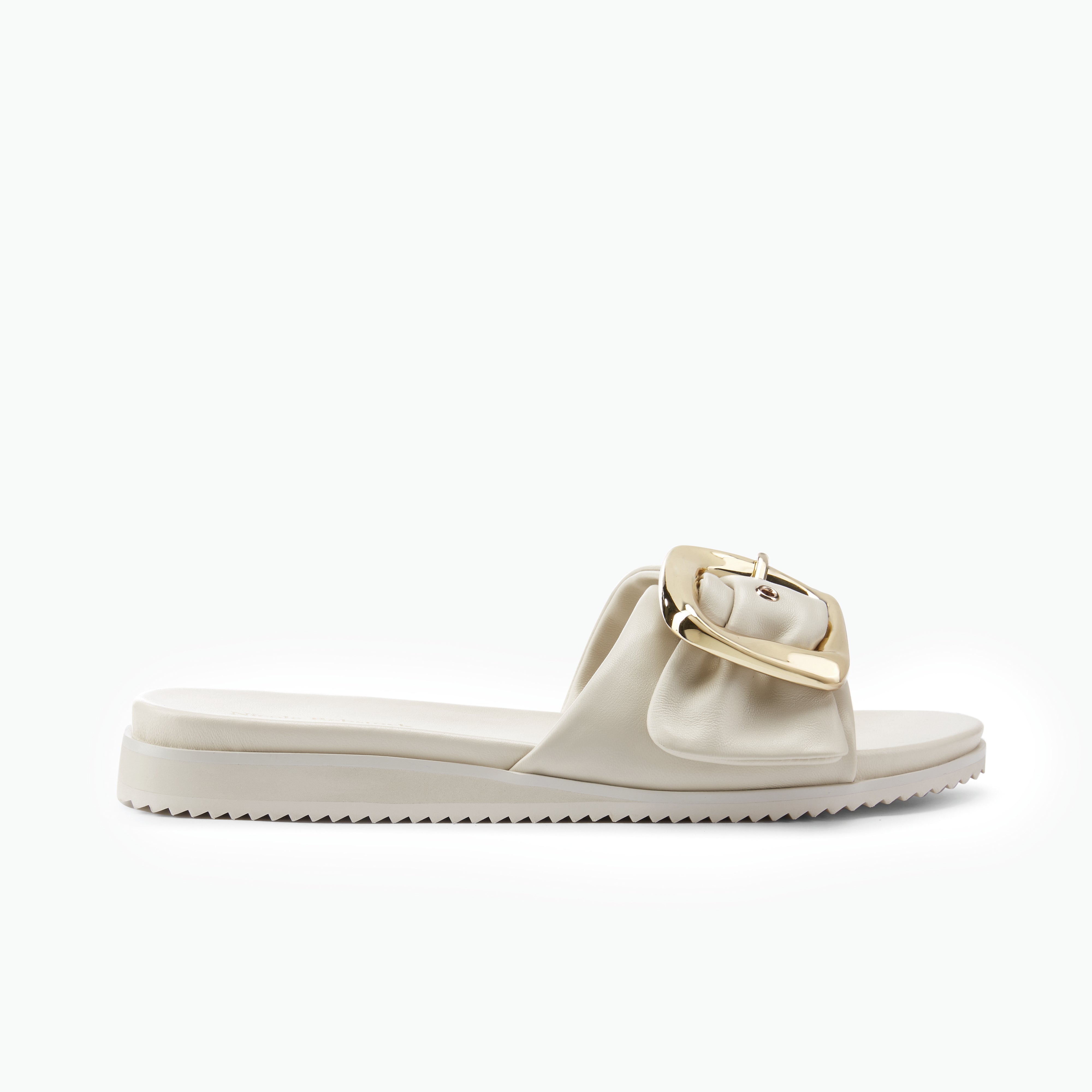 Off white sandal with a gold buckle on a white background