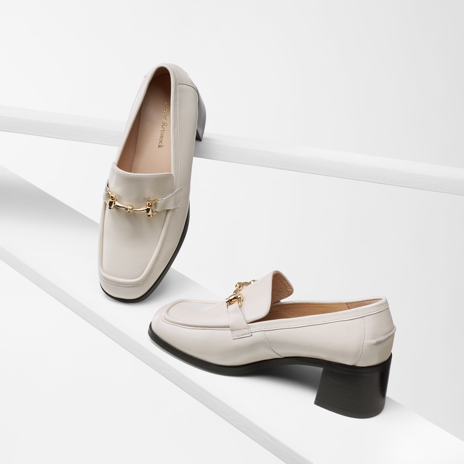 Bremen loafer in ivory leather shown from different angles. Black 4.5cm block heel with gold metal chain.