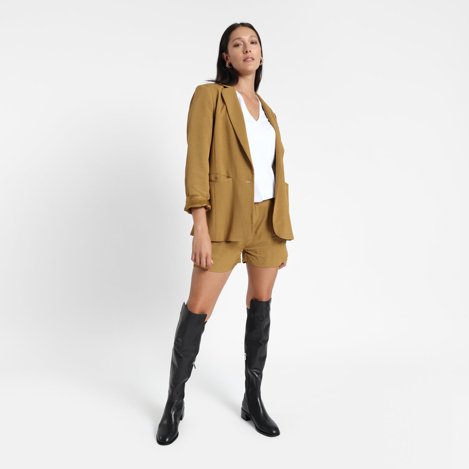 Brussels black leather knee high boots worn by model.