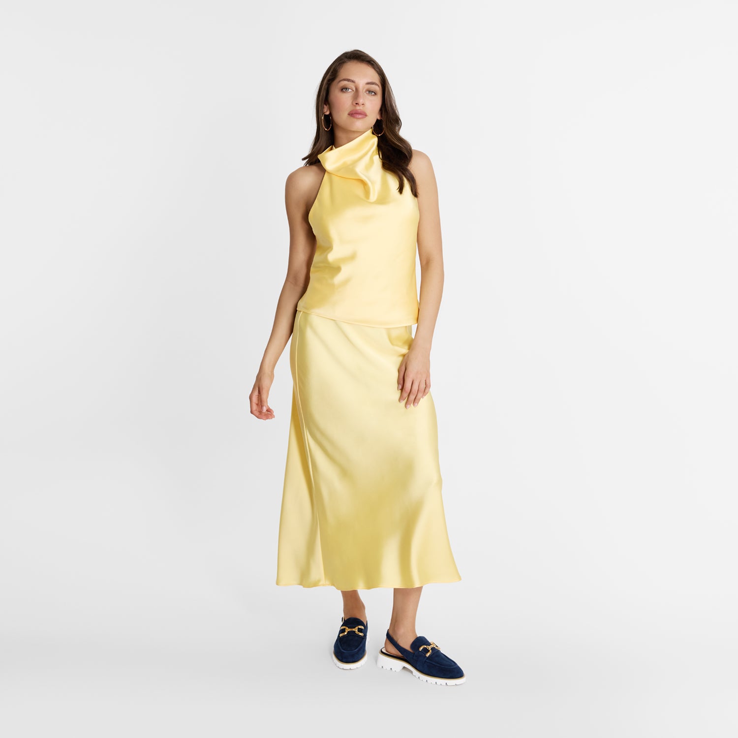Woman wearing a yellow dress with navy slingback loafers by Nicole Rebstock
