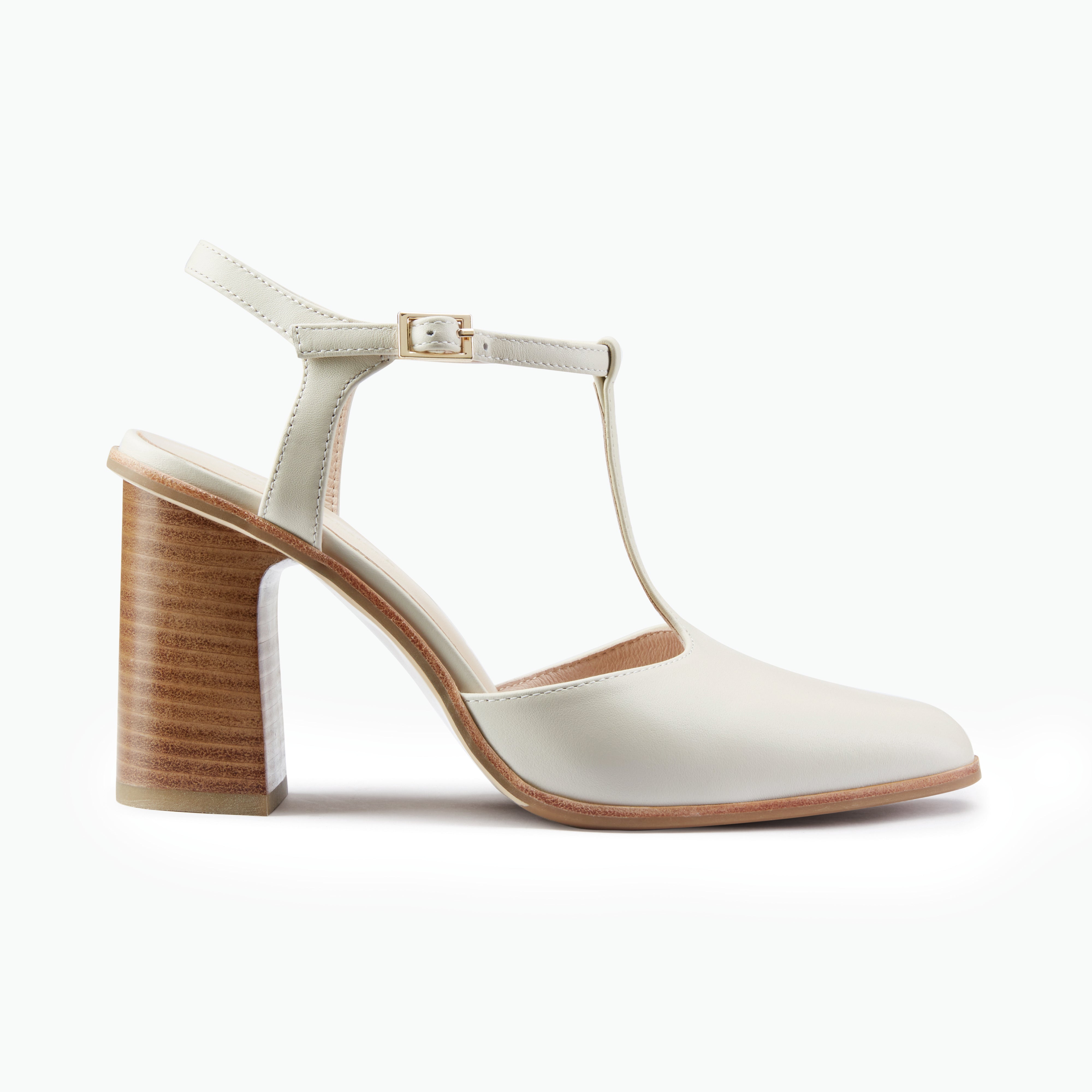 Beige T-bar heels with wooden heel on a white background