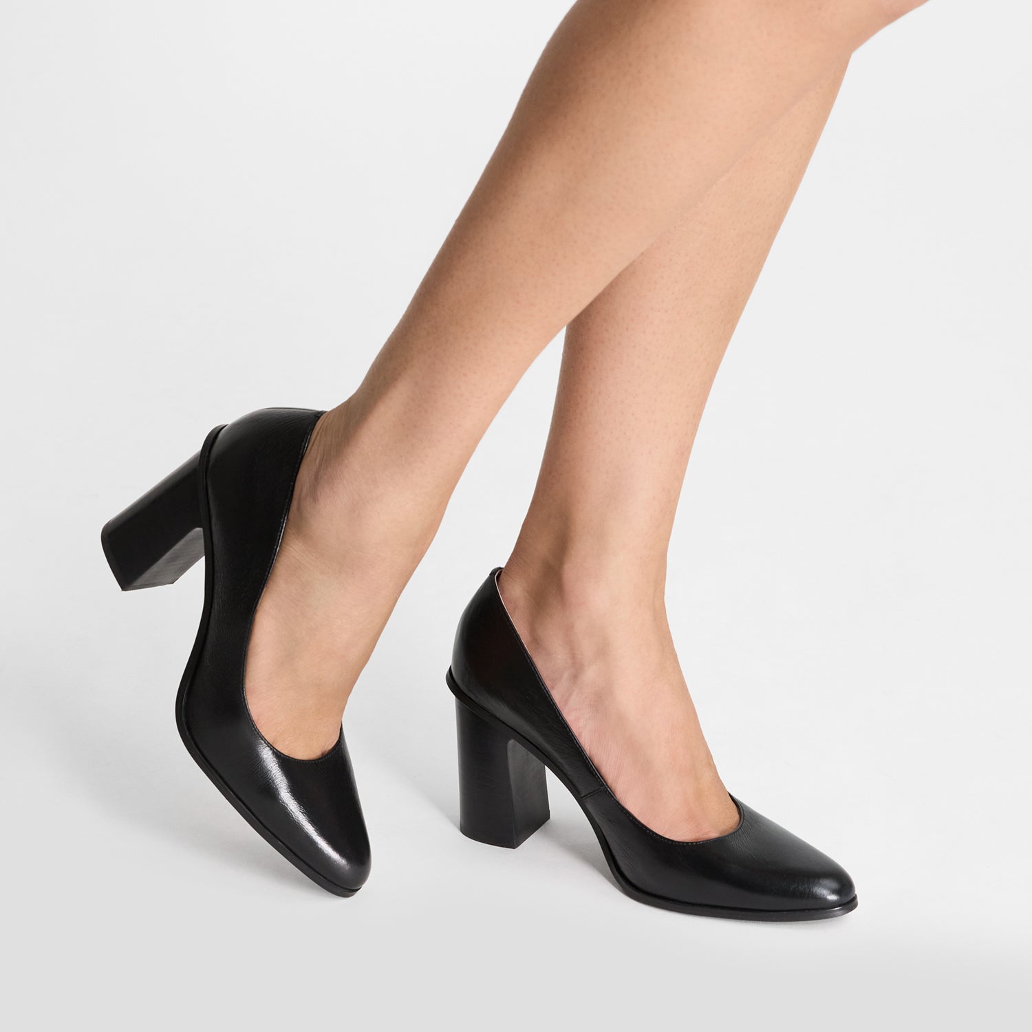 Black high-heeled shoes by Nicole Rebstock with almond toe. Medium block heel.