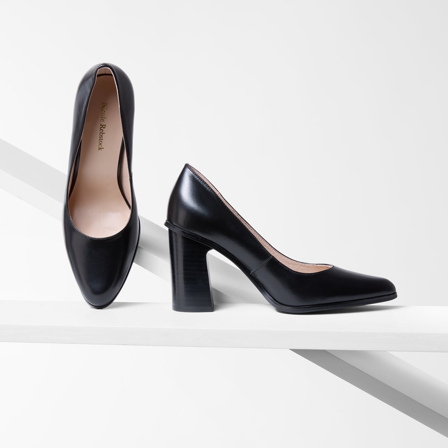 Black high-heeled shoes on a white background with an almond toe. 8.2cm heel.