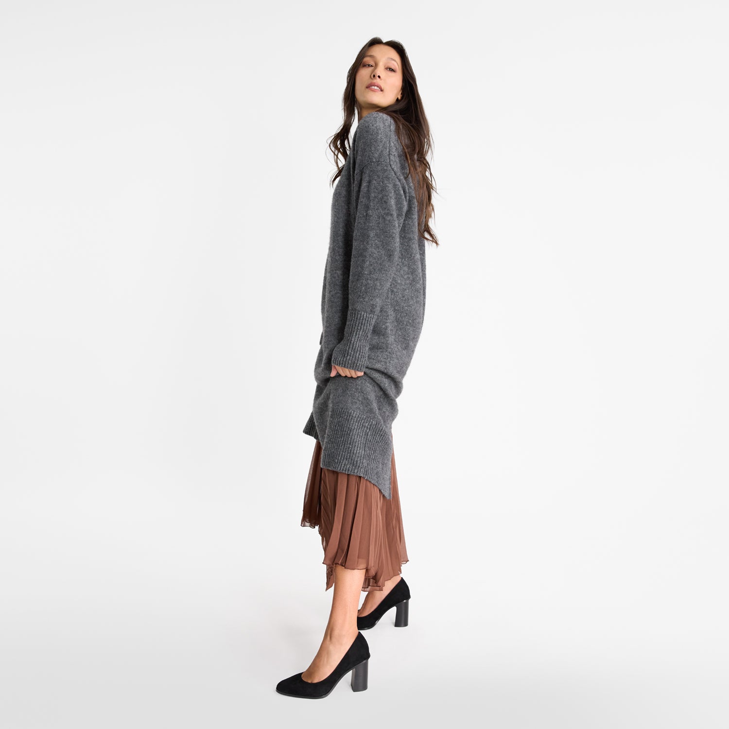 Model wearing black suede block heel pumps.