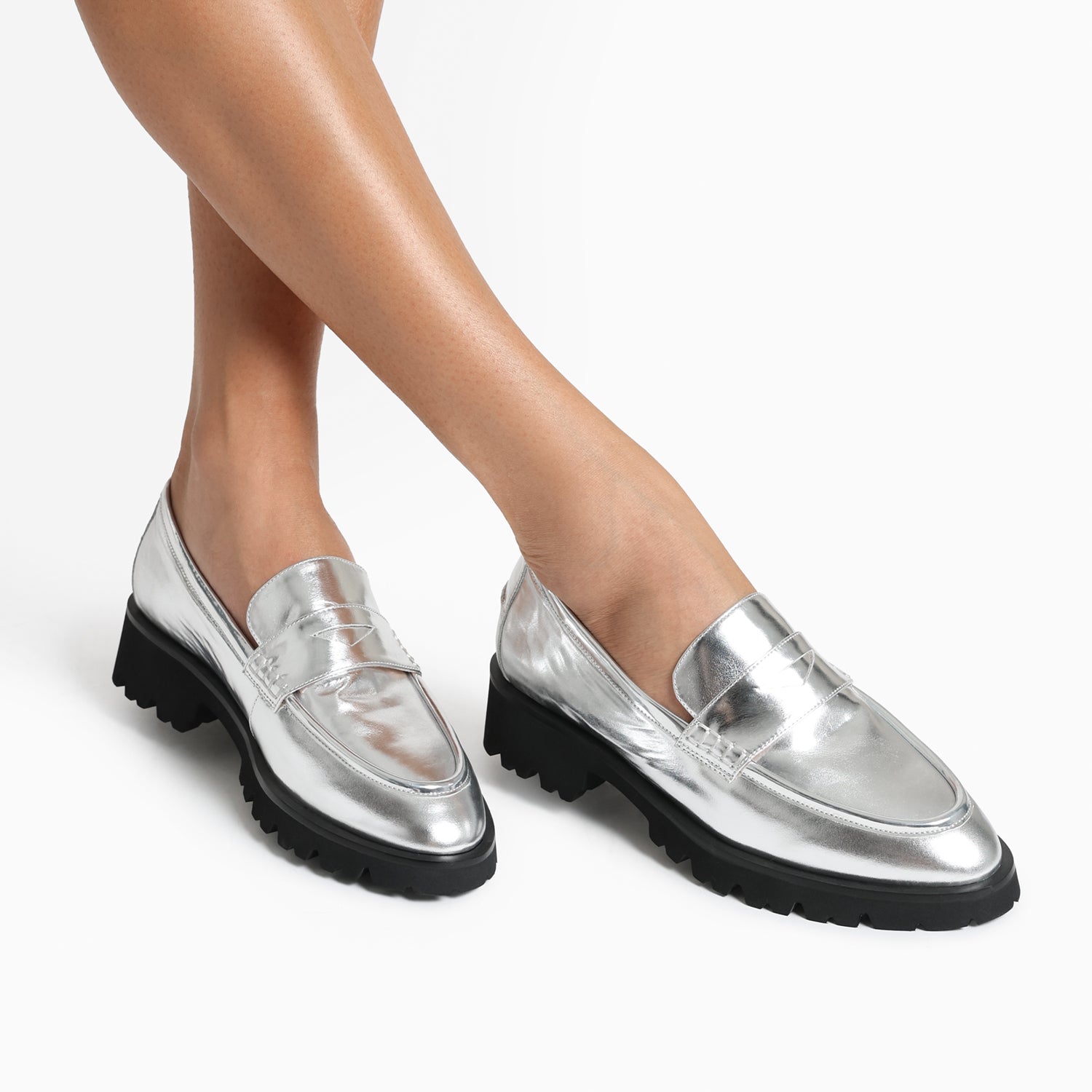Close up of Czech Loafer in silver. Worn by women. Chunky black sole.