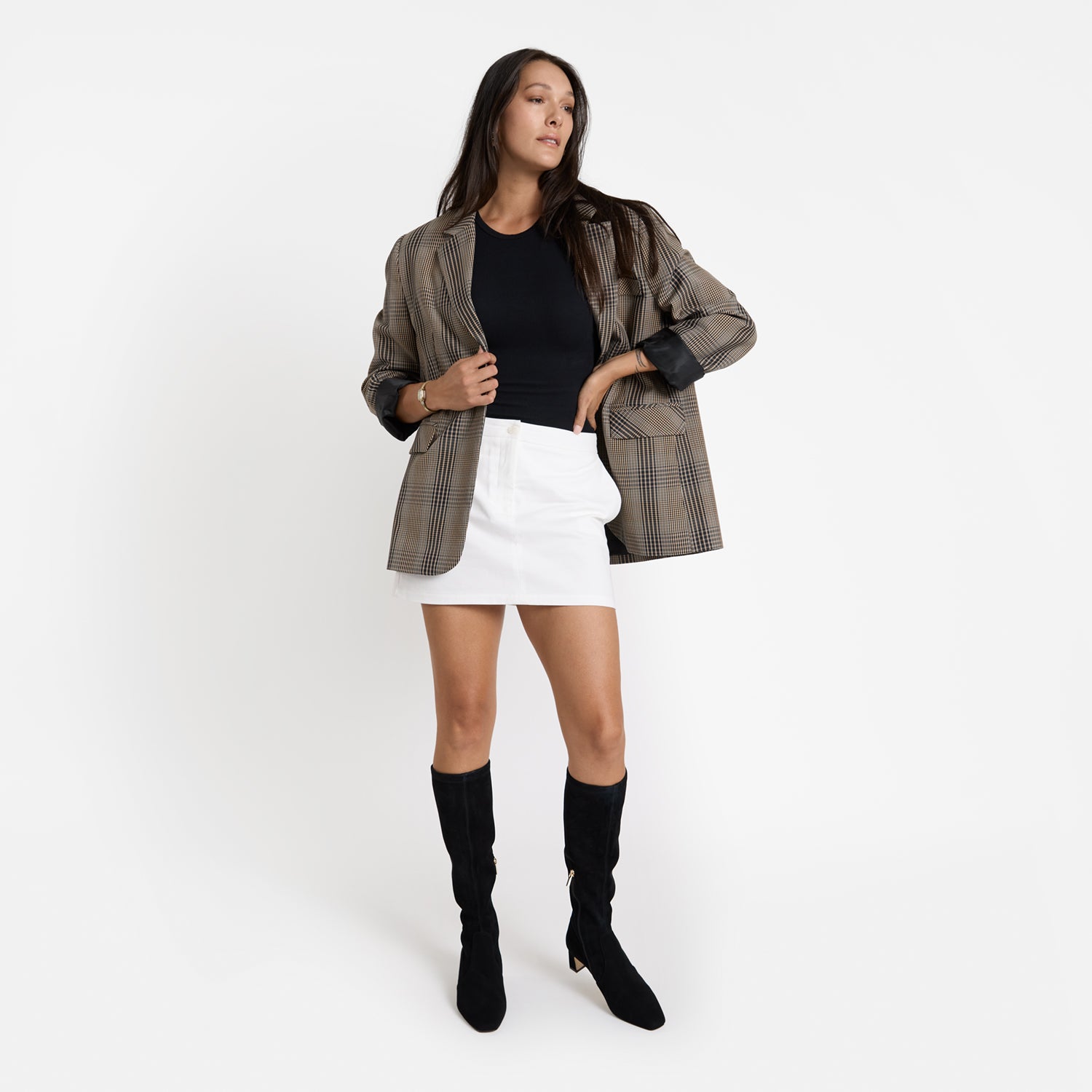 Woman wears limited edition Dakota black knee high boot with square/pointed toe. Heel height is 5.5cm.