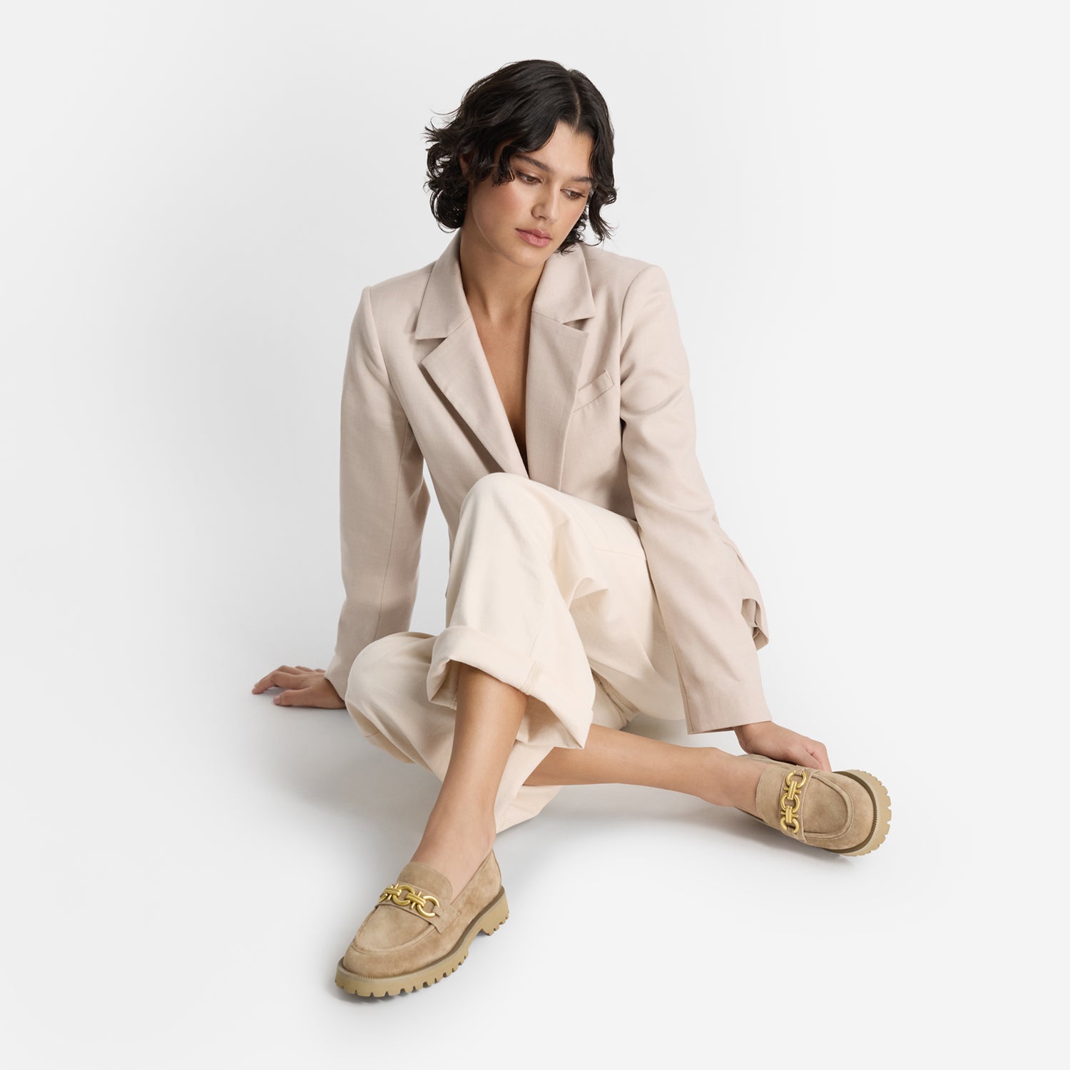 Model wearing Nicole Rebstock's chinky Dee Loafers in natural suede leather.