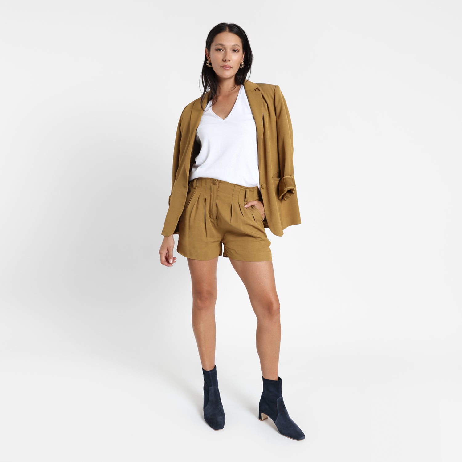 Demi navy suede with kitten heels worn by model wearing a mustard coloured suit and white top.