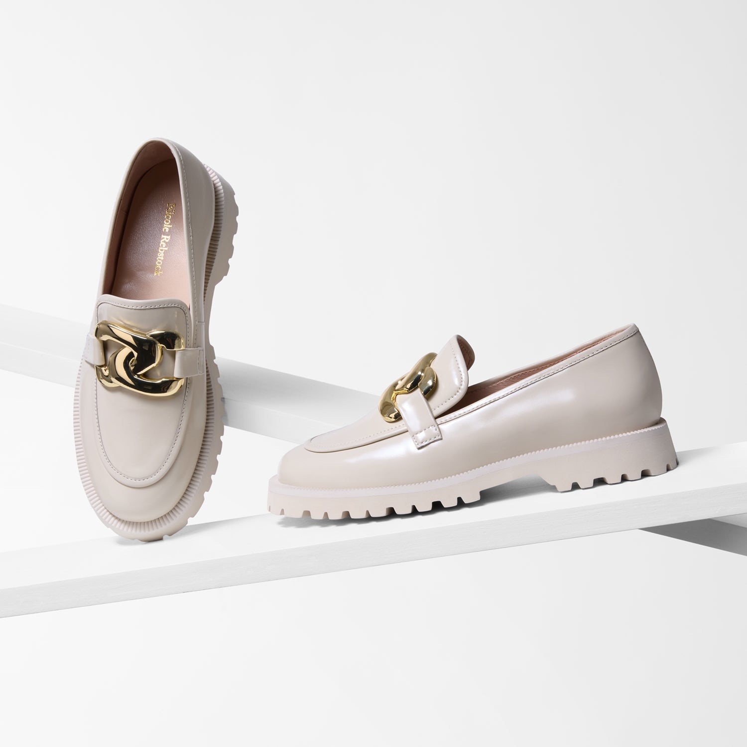 Pair of ivory loafers with gold details and chunky sole.