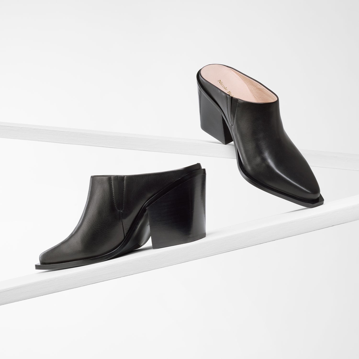 Fabio black leather mule on planks shown from all angles.