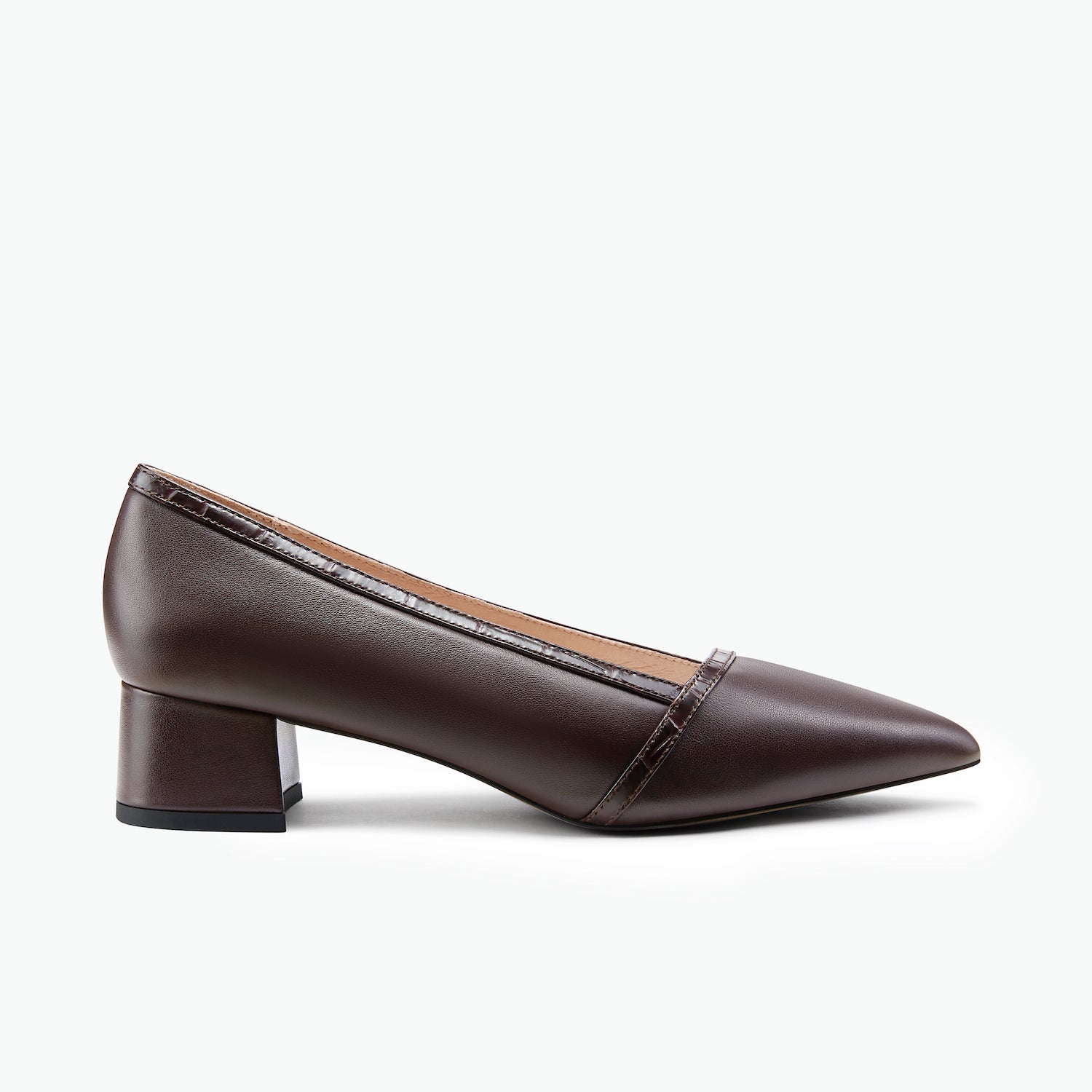 Brown leather pointed toe pump with a small heel on a white background