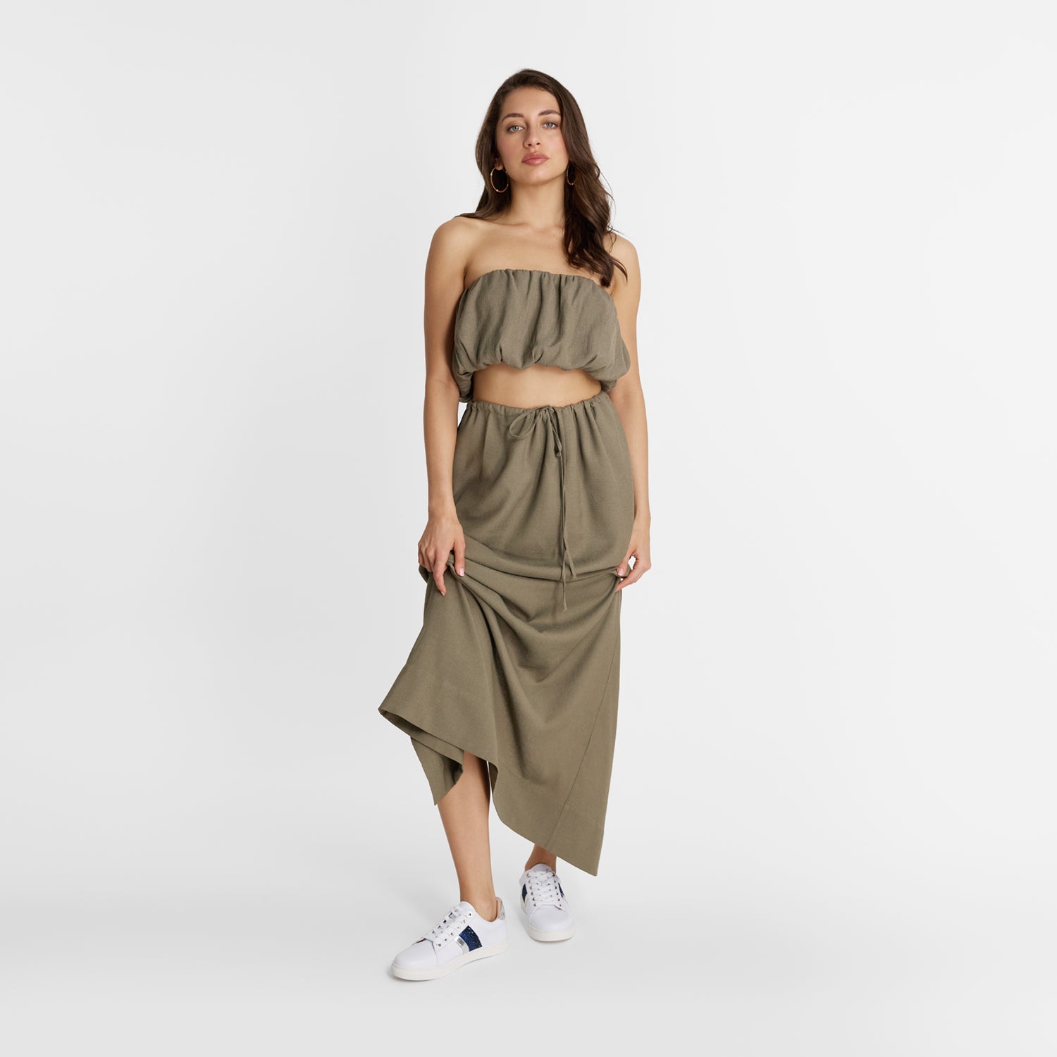 Model wears Nicole Rebstock Gigi Sneaker with white upper and blue and silver stripes and white laces. Comfortable.