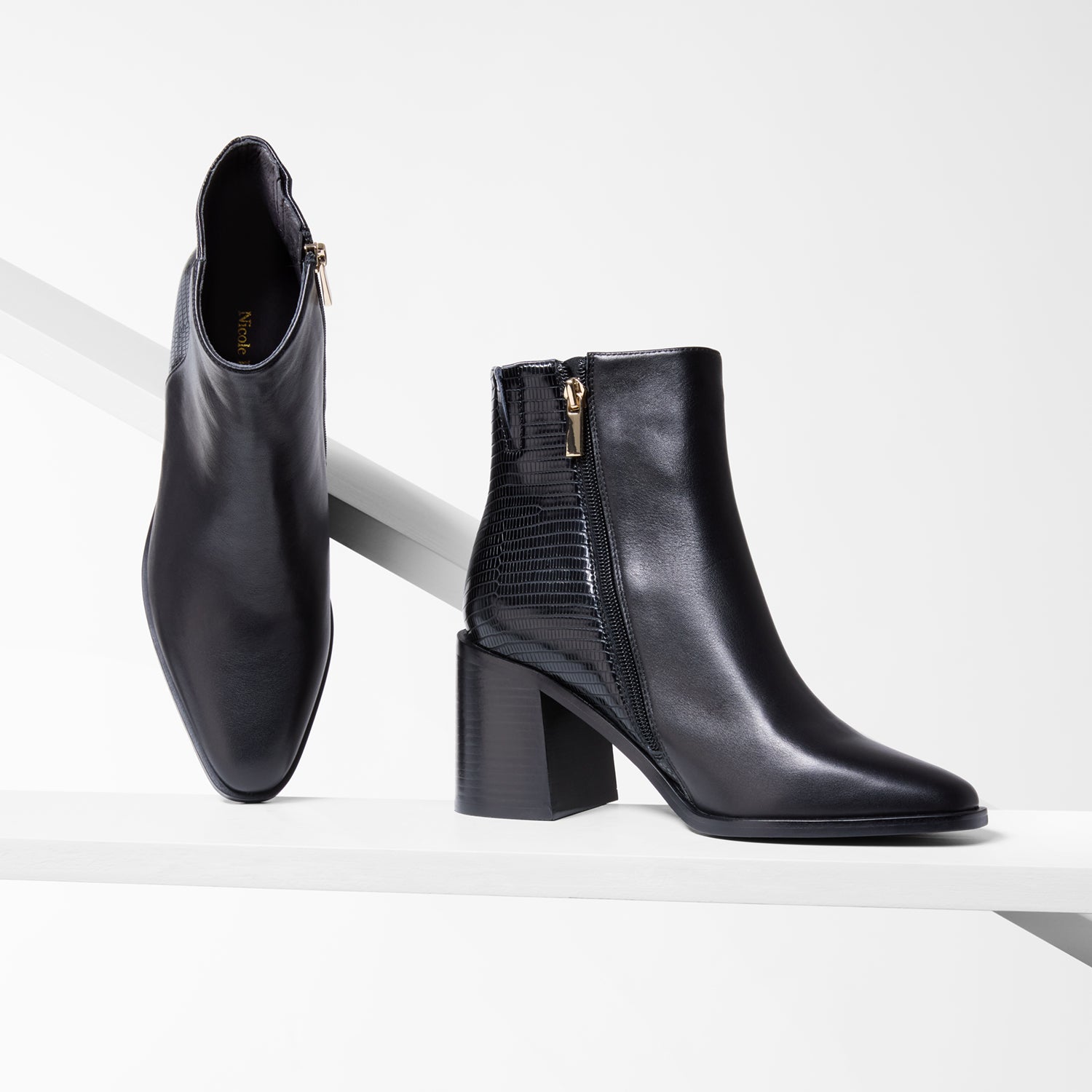 Black leather ankle boots with a block heel on a white background. 8cm heel. Almond toe.