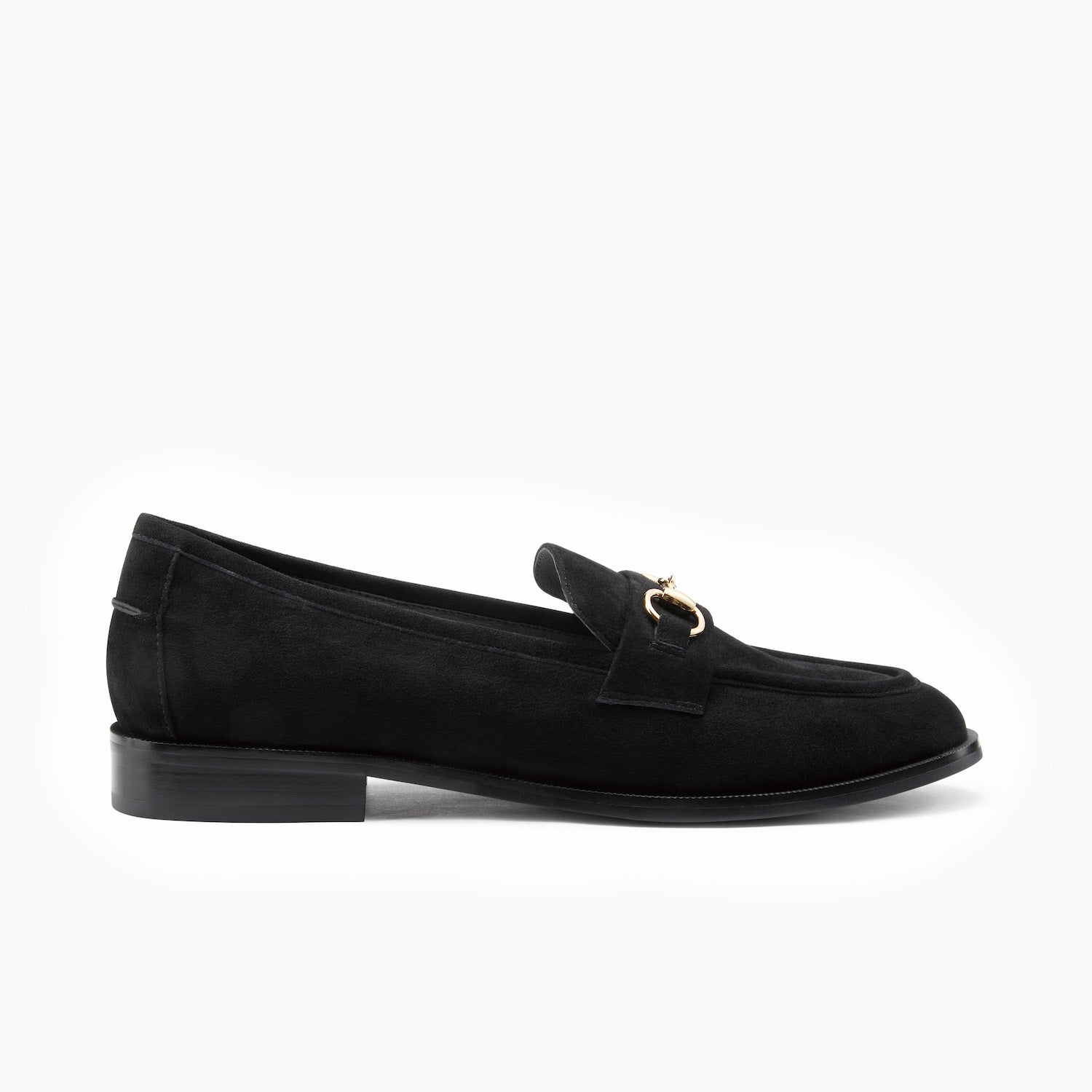 Black suede loafer with a gold horse bit on a white background