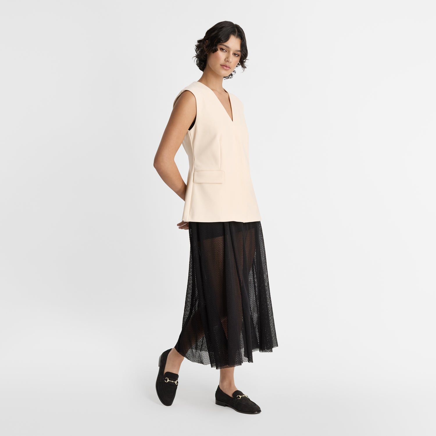 Model wears Nicole Rebstock's Harriet Loafers in black suede.