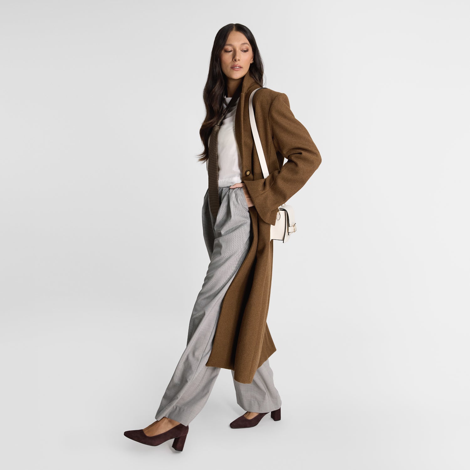 Model wearing Nicole Rebstock's Isla pumps in choc cherry with block 6.5cm heel.