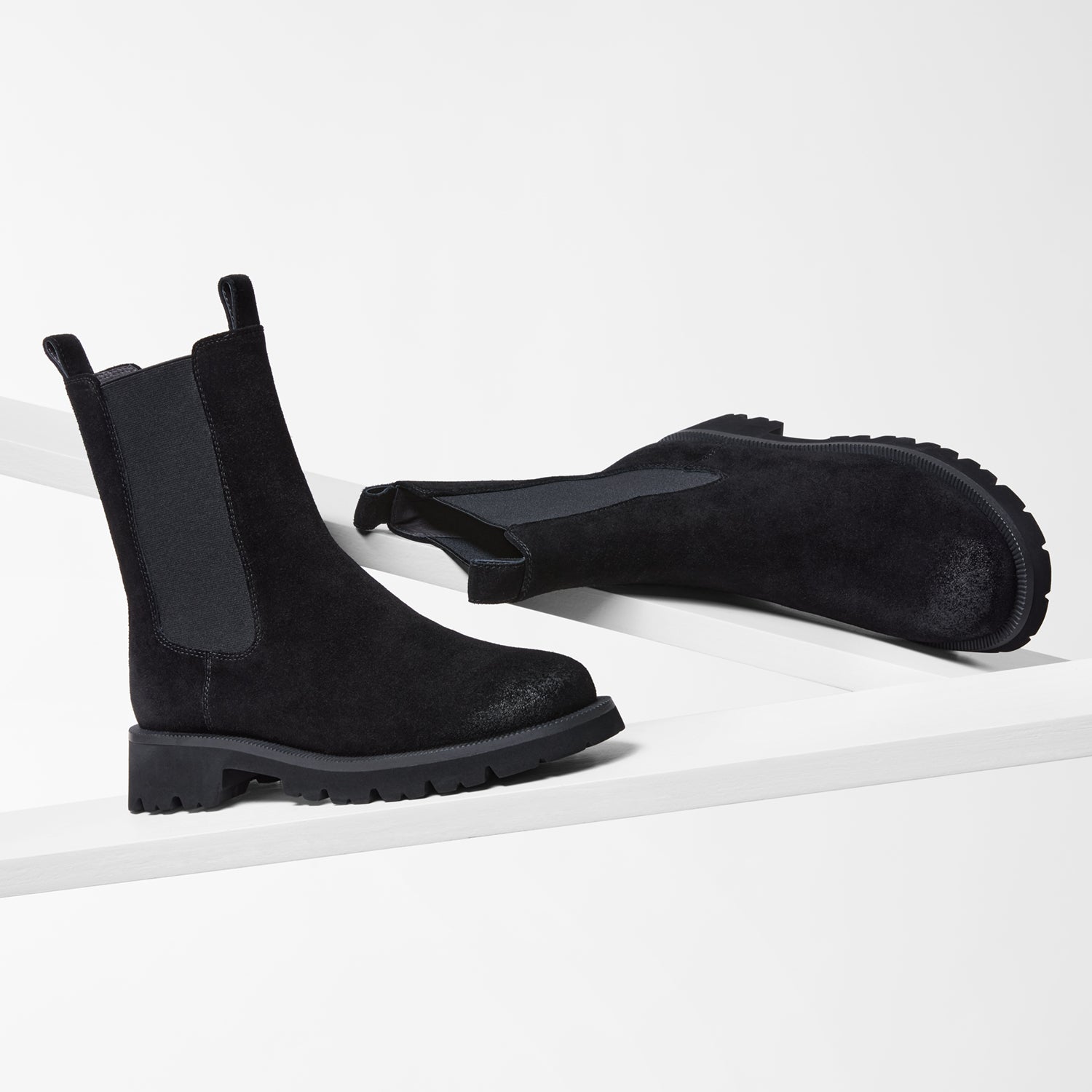 Black chelsea boots shown from various angles.