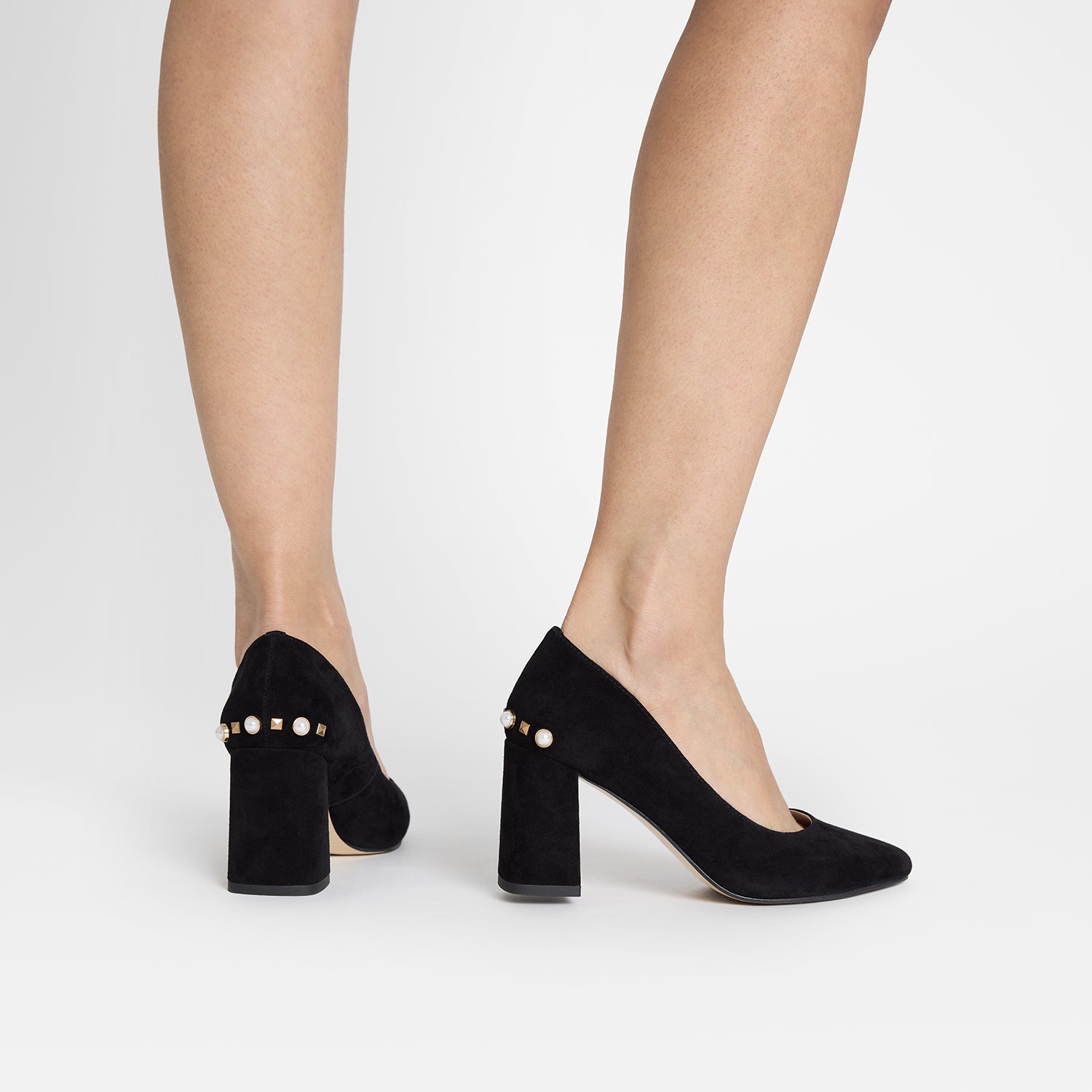 Jen black suede heel worn by woman. They have a cushioned insole and slip proof soles. 