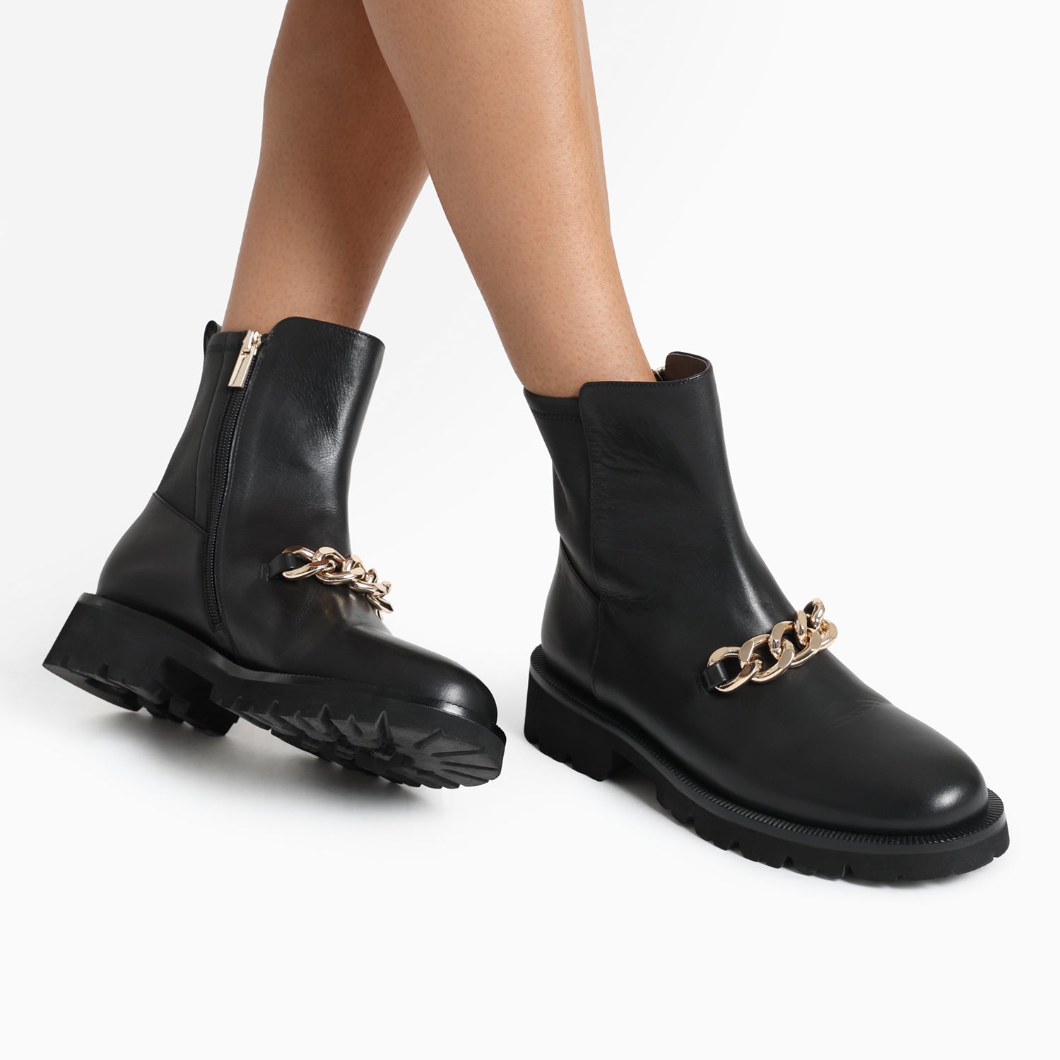 Jimmy Ltd Ed black thick tread flat ankle boot worn by model.