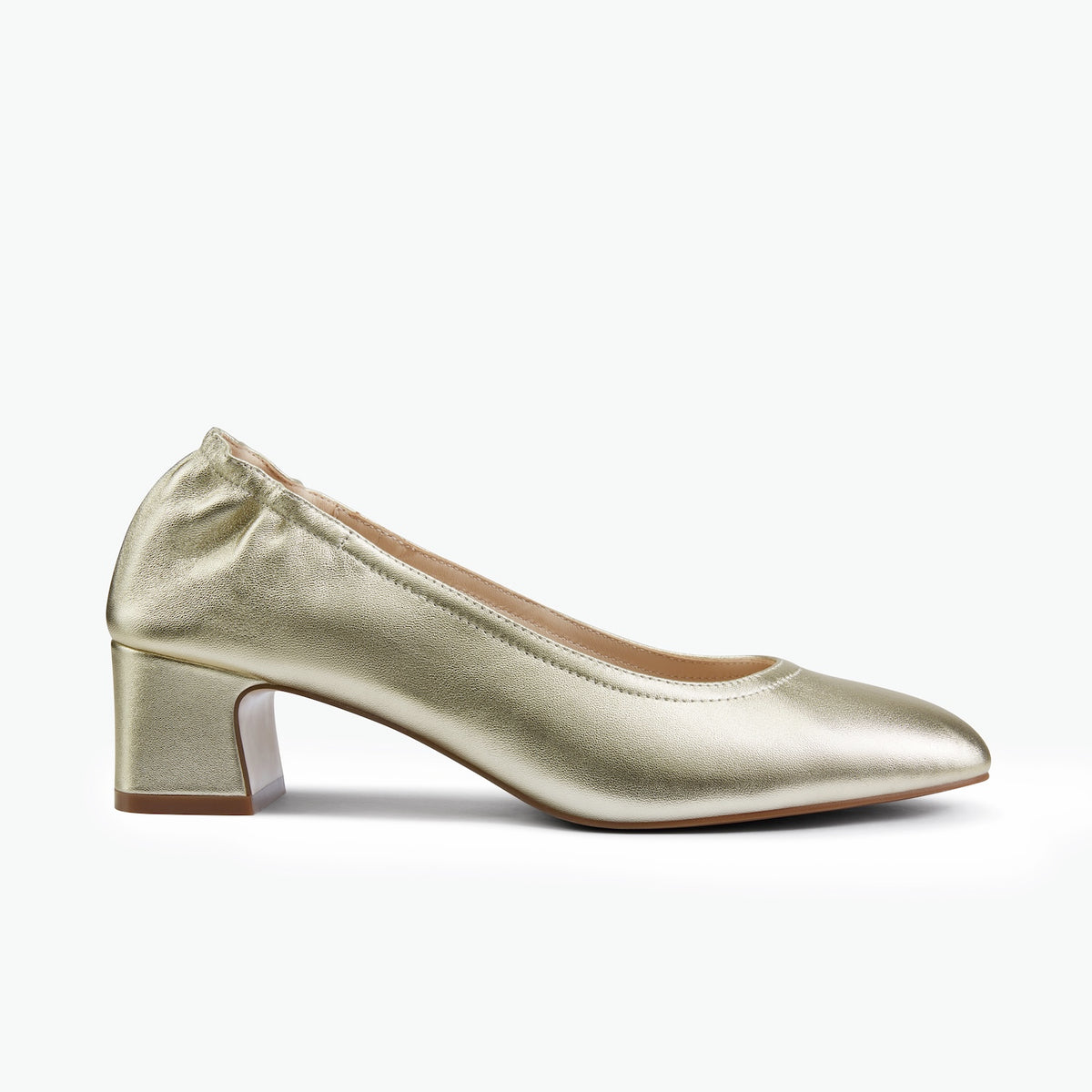 A single metallic gold pump shoe with a block heel and pointed toe, shown in profile against a clean white background.