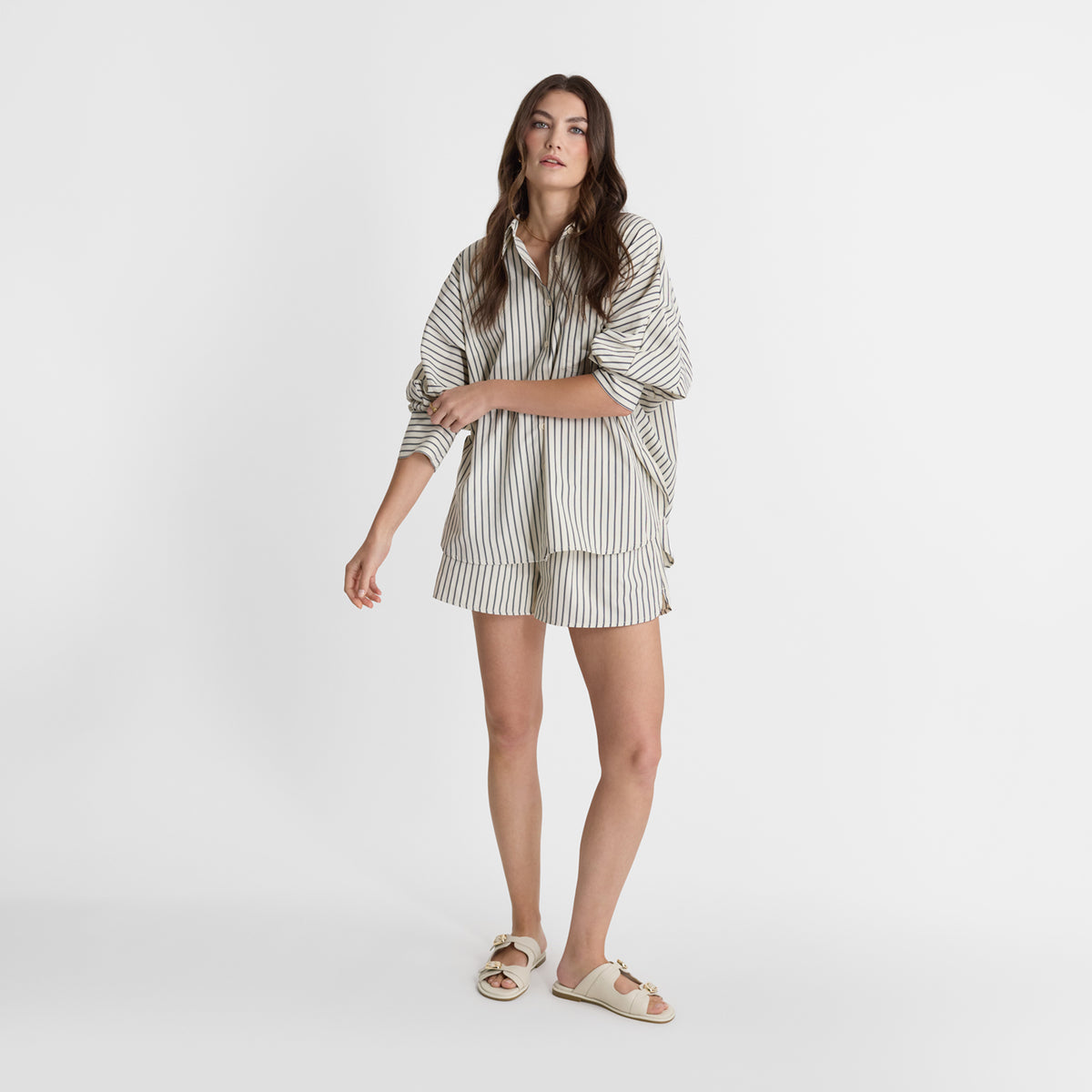 Model wearing Nicole Rebstock's warm ivory leather flat Liam slides.