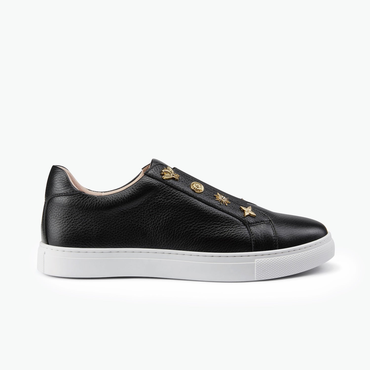 A single black pebble leather sneaker with gold unique studs and a white sole on a white background.