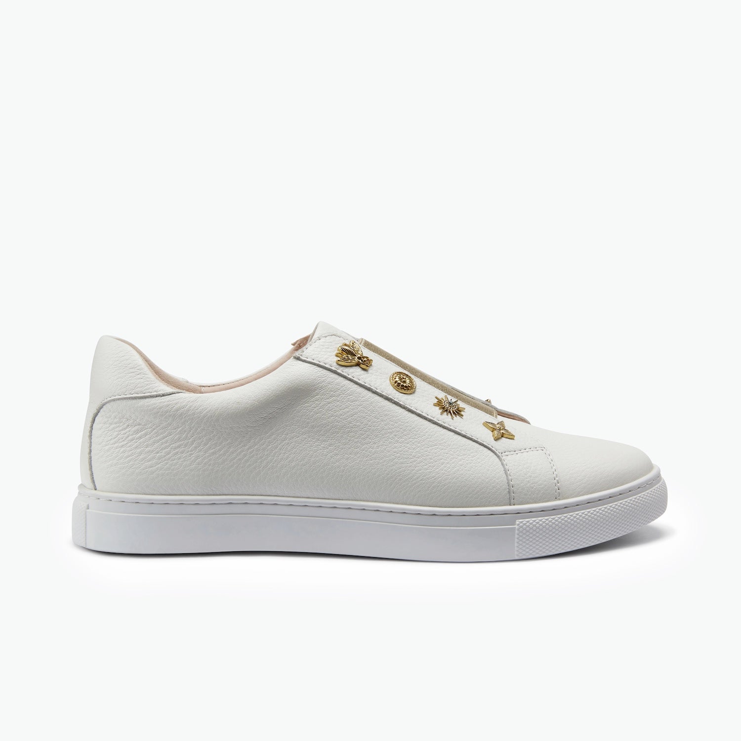 Off-white slip on sneaker with unique gold studs on a white background.