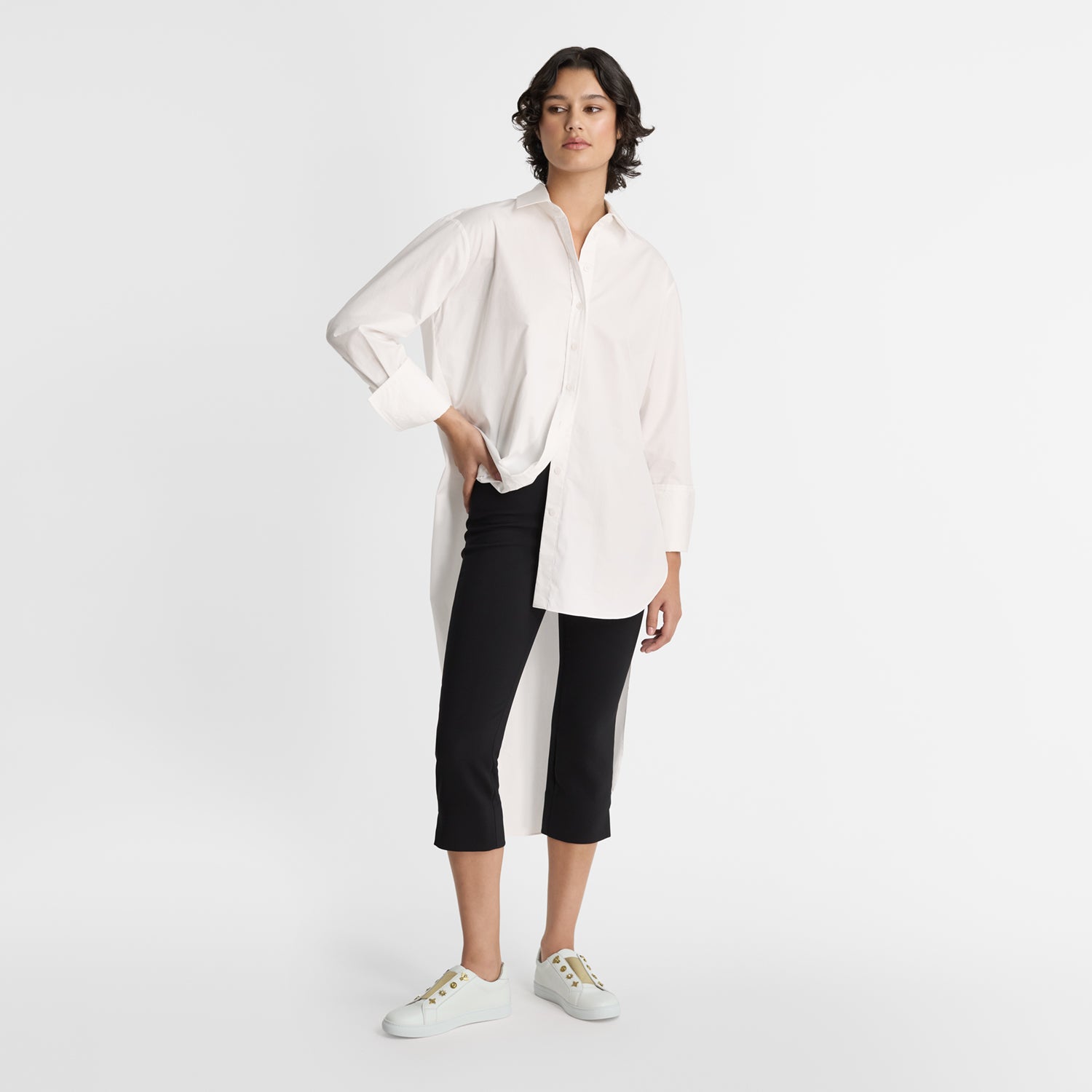 Model wearing Nicole Rebstock's Mable Sneakers in off-white.
