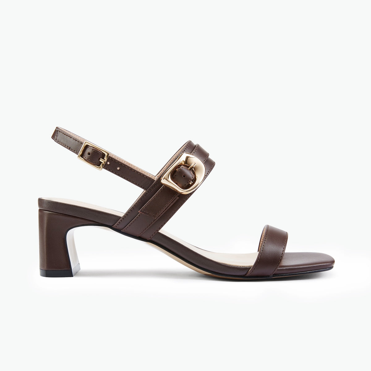 A dark brown leather block-heel sandal with a low square toe, a single front strap, and an ankle strap featuring a gold-tone buckle, shown in a side profile on a light gray background.