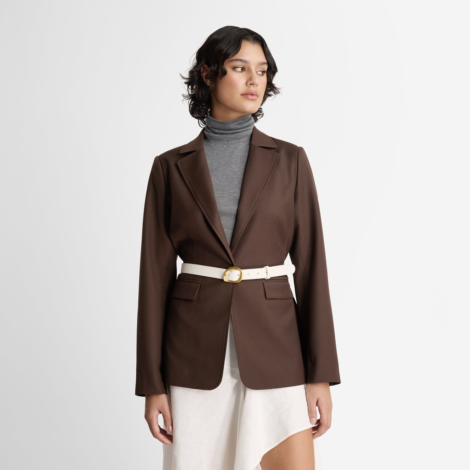 Model wearing Nicole Rebstock's cream leather belt with gold metal buckle.