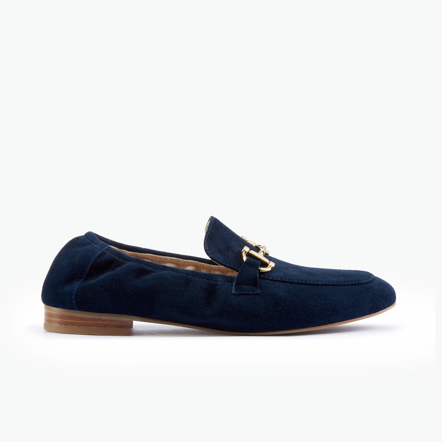 Navy blue suede leather loafer with a gold buckle on a white background by Nicole Rebstock