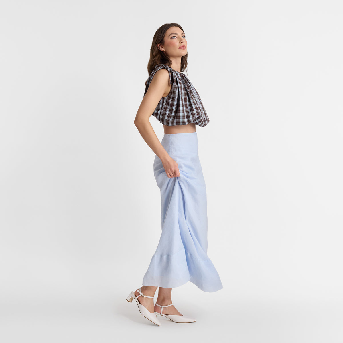 A model wearing Mia Heels with ankle strapp and square toe.