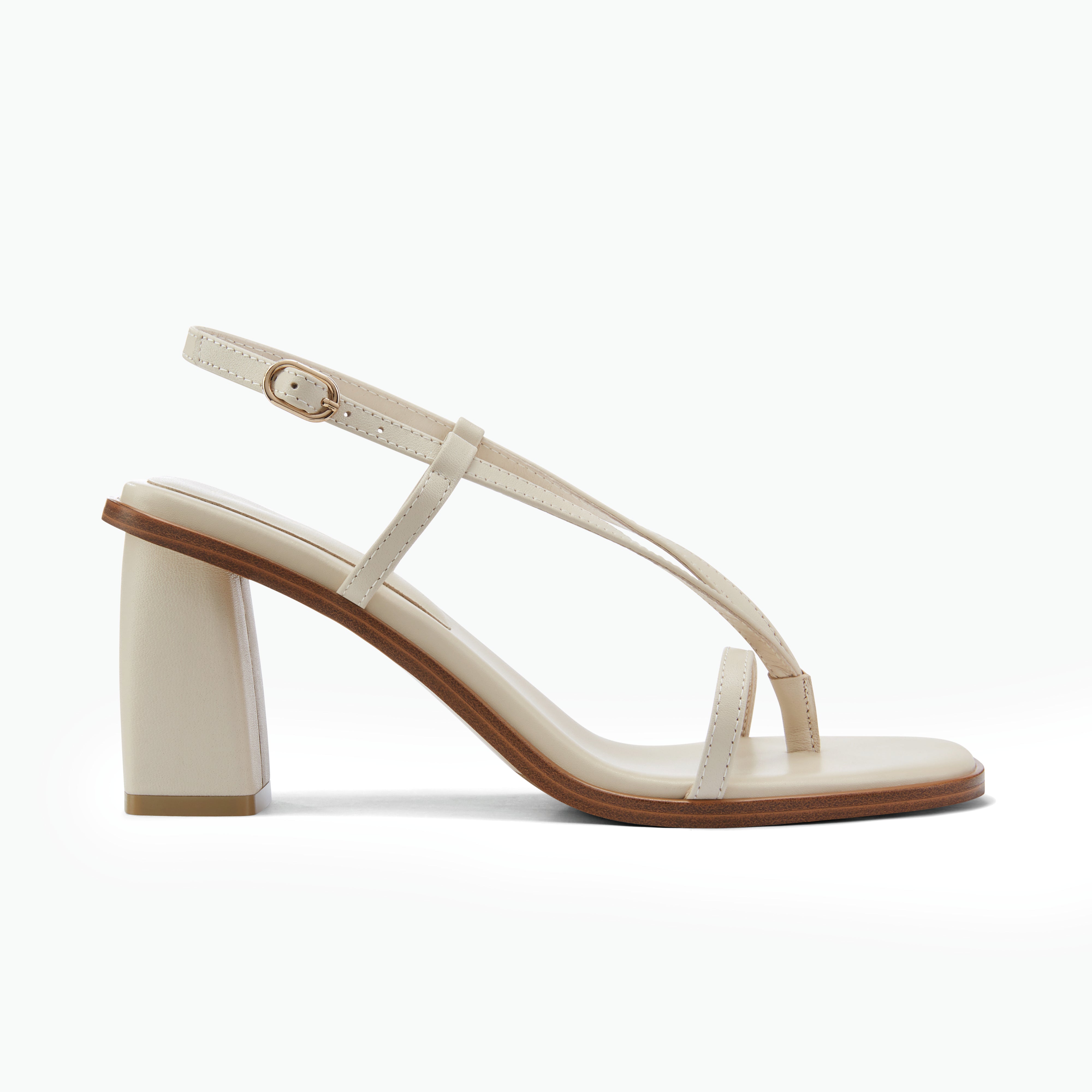 Beige sandal with a block heel on a white background by Nicole Rebstock
